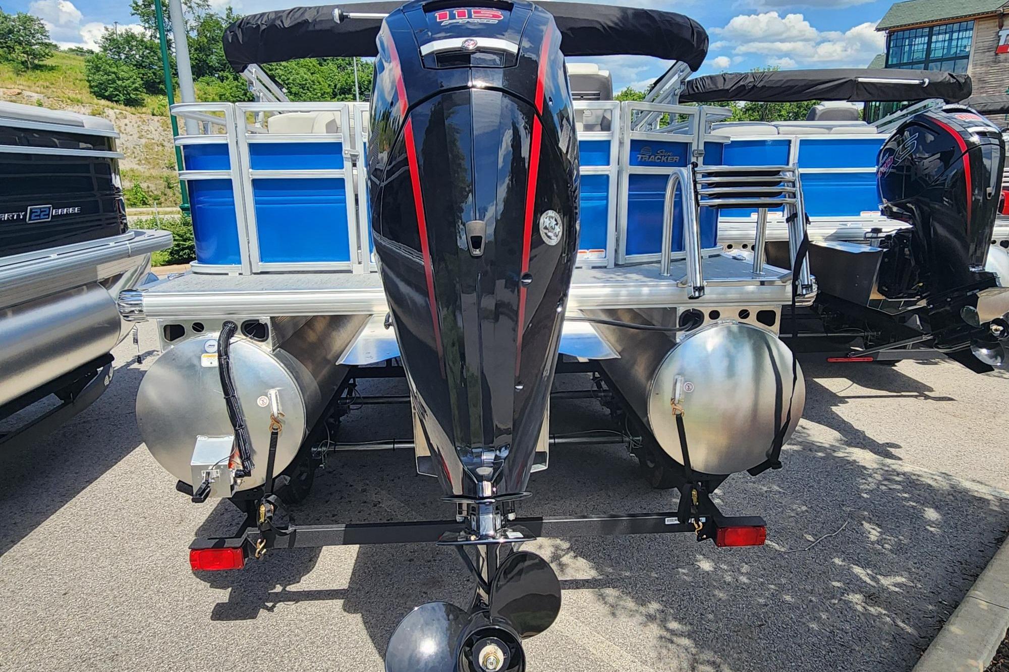 2026 Sun Tracker Fishin' Barge 20 DLX pontoon boat with powerful outboard motor.
