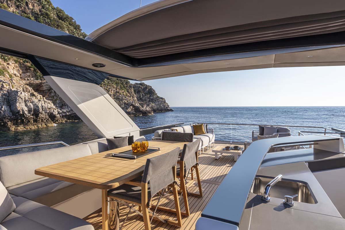 Manufacturer Provided Image: Luxurious 2022 Absolute 64 Navetta yacht with elegant outdoor dining area and stunning sea view.