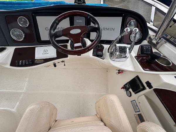 2010 Meridian 441 Sedan helm with Garmin navigation, steering wheel, and control panel.