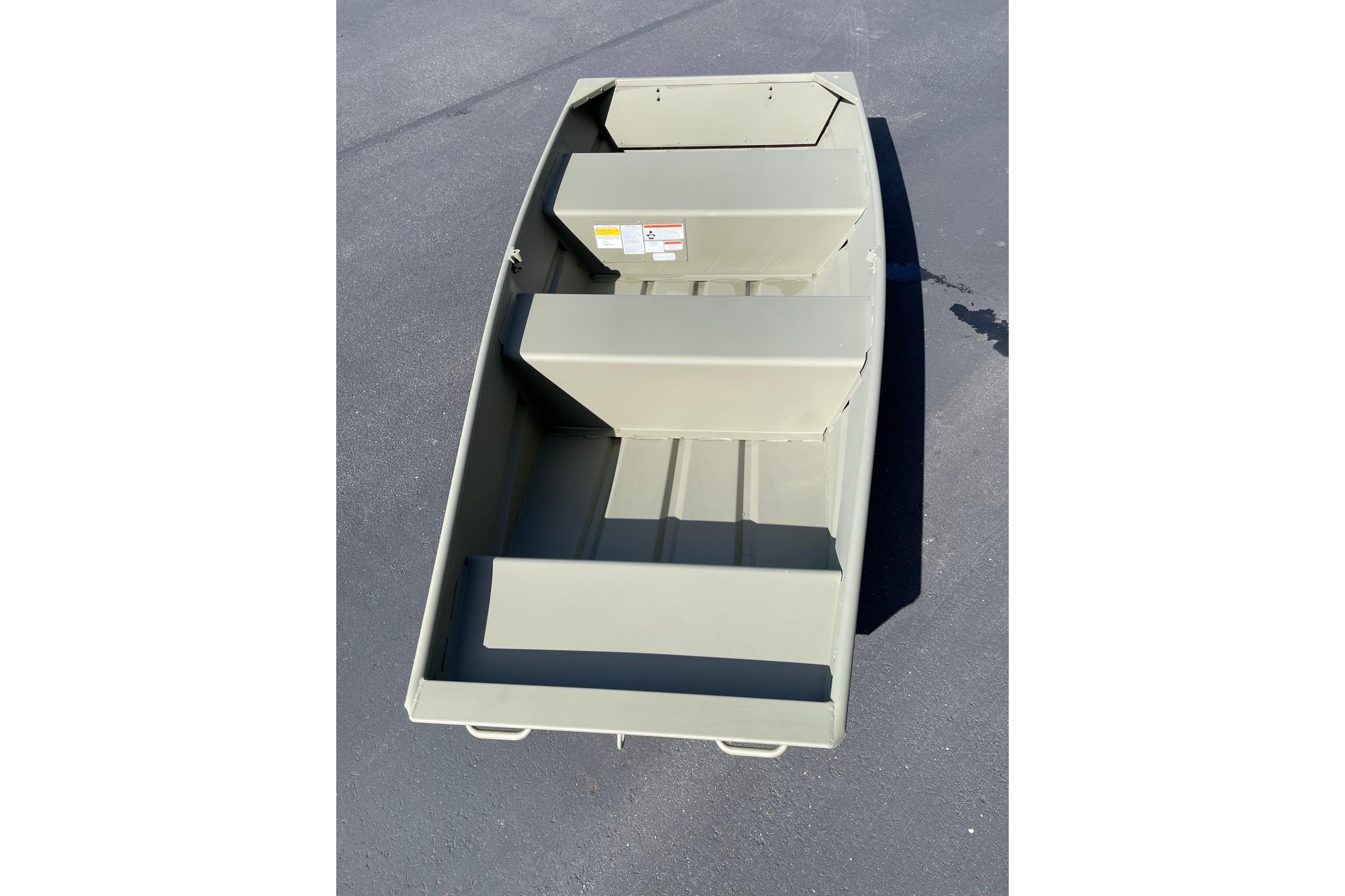 2026 Tracker Grizzly 10 Jon boat on pavement, showcasing interior seating and design.