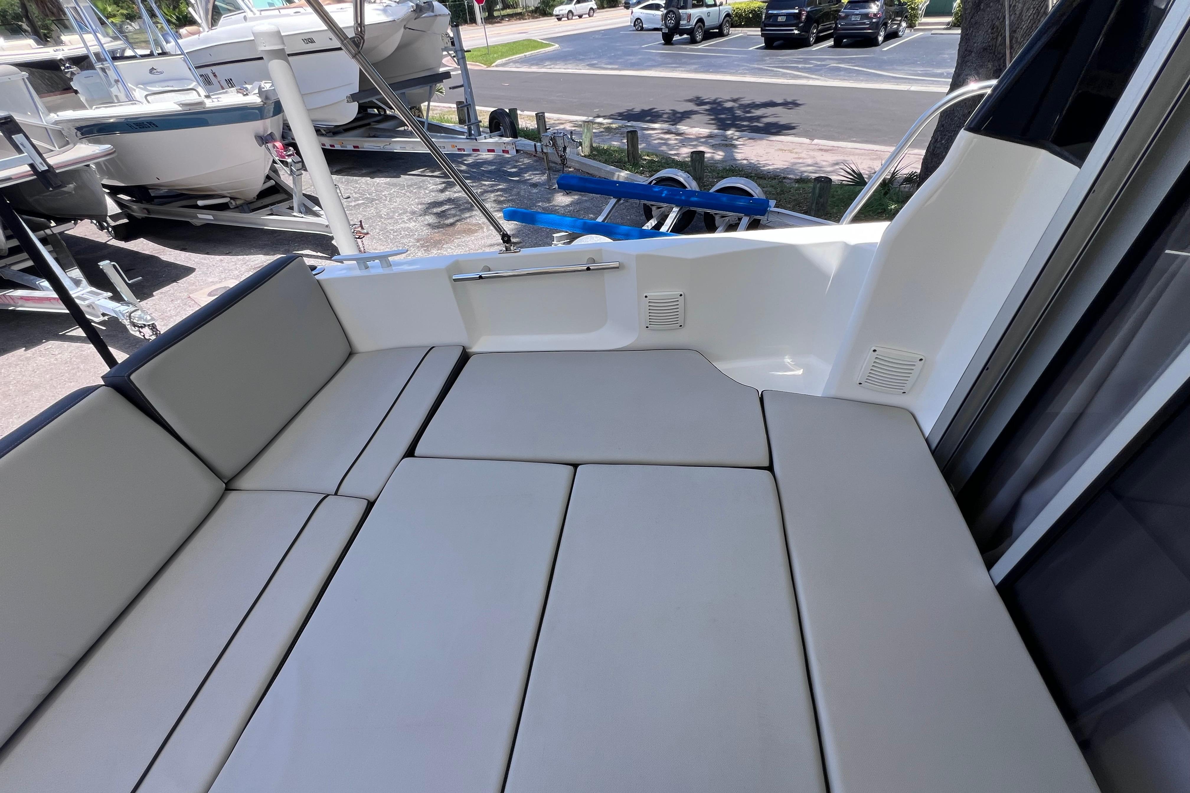 Interior seating of 2021 Jeanneau NC Weekender 795 Series 2 boat, featuring cushioned benches.