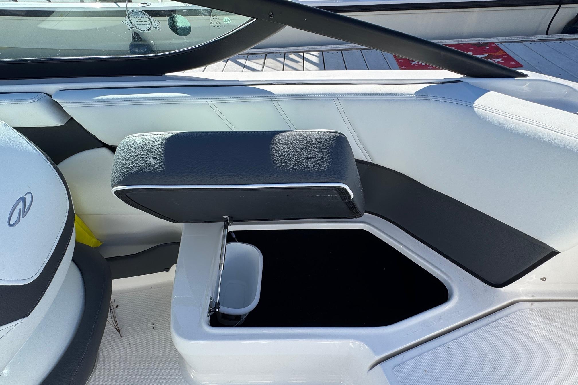 2026 Regal 21 OBX boat interior with open storage compartment and cushioned seating.