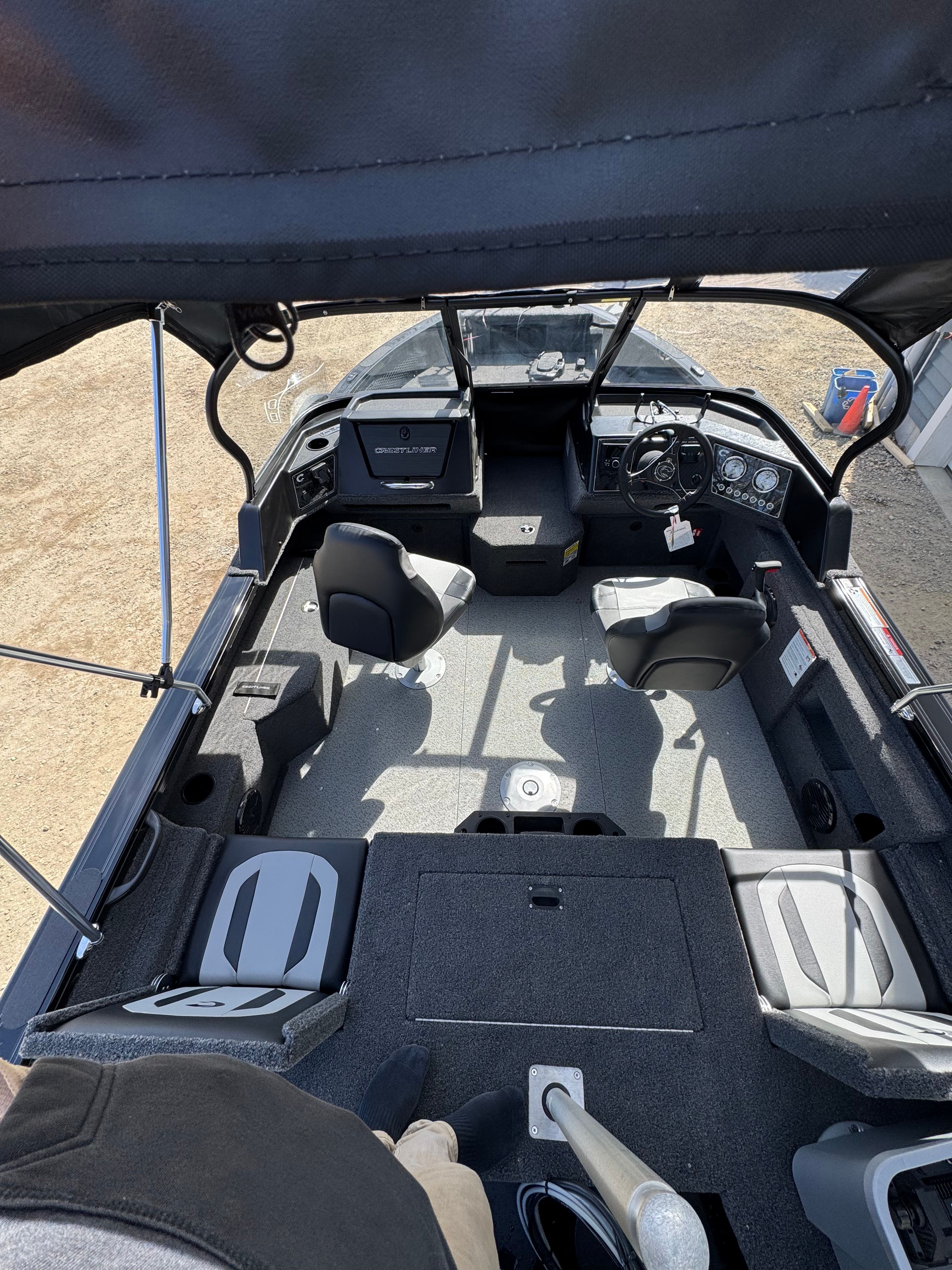 Interior view of a modern boat with seating and a control console.