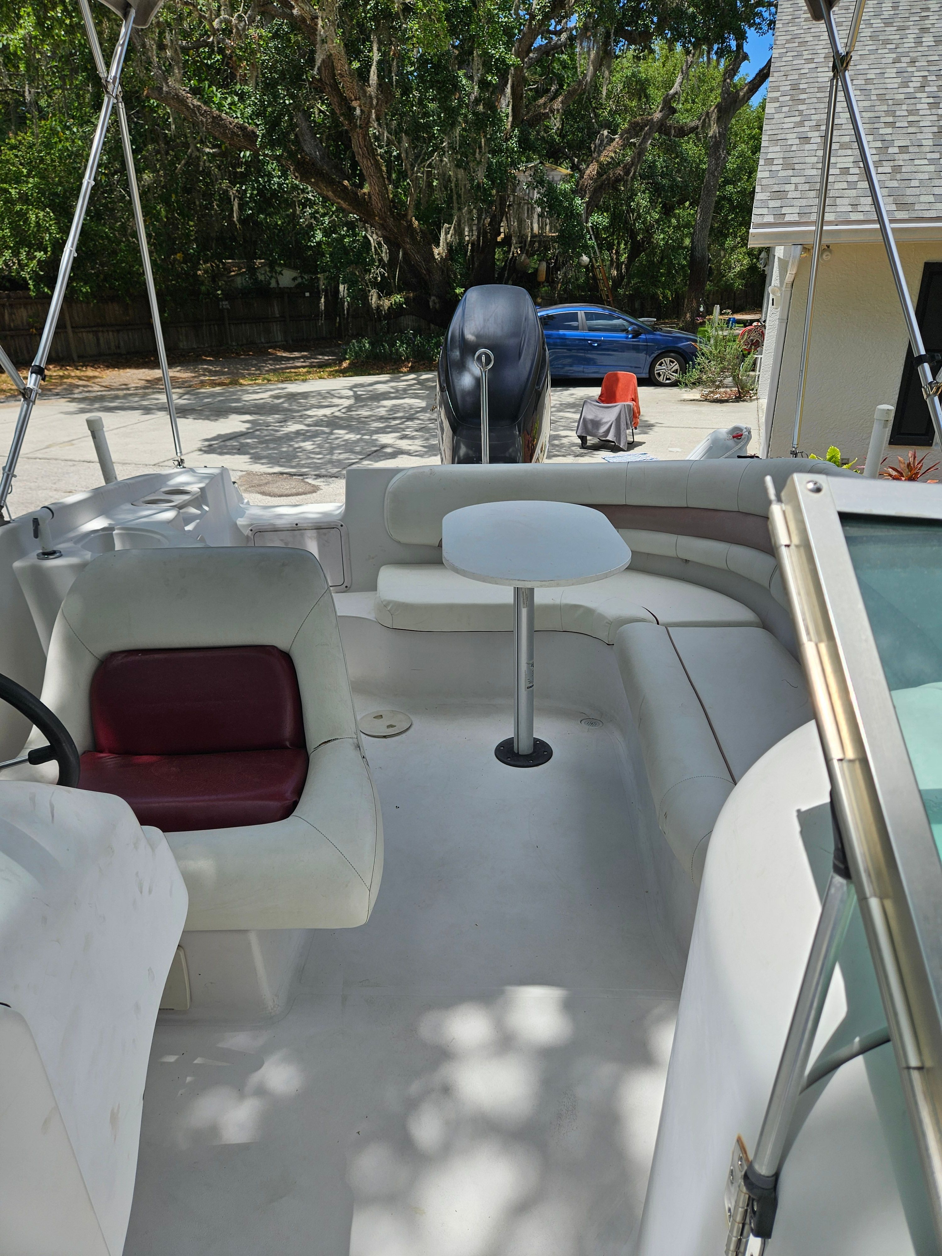 The image shows the cockpit of a 2001 Hurricane 237 boat. It features white seating and a steering wheel.