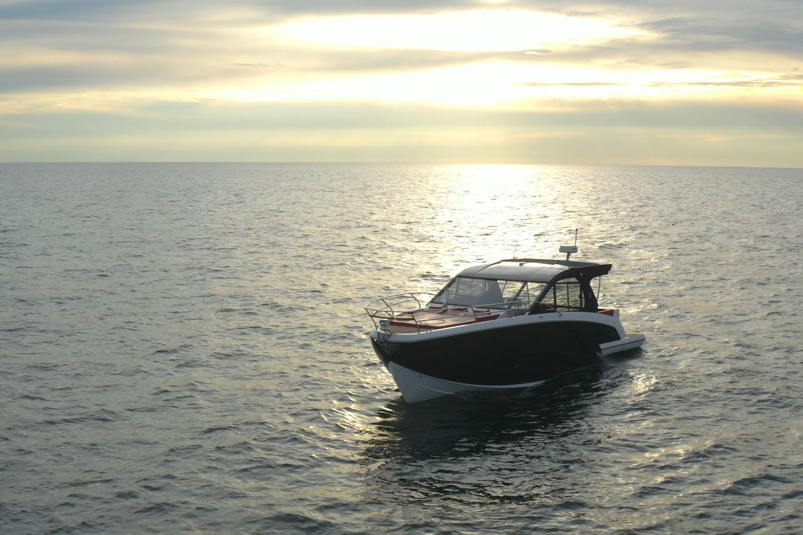 Luxury Hanover 387 boat on serene ocean at sunset, 2026 model.