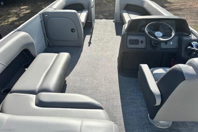 2026 Sun Tracker Party Barge 18 DLX interior with spacious seating and modern helm.