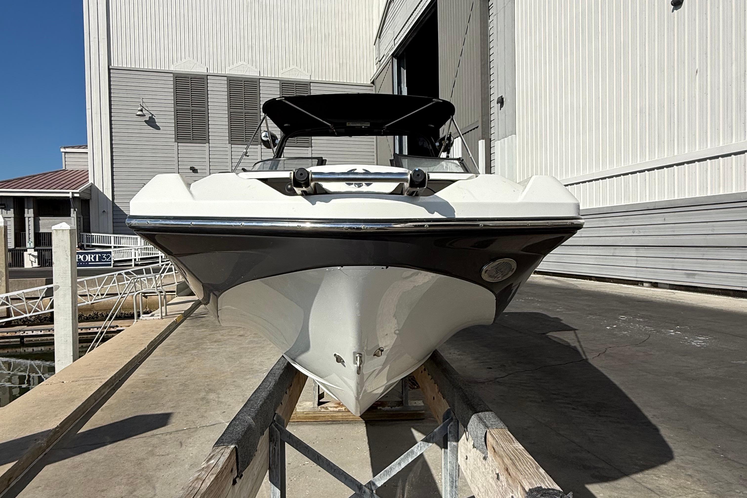 2021 Scarab 255 ID boat docked at marina, front view.