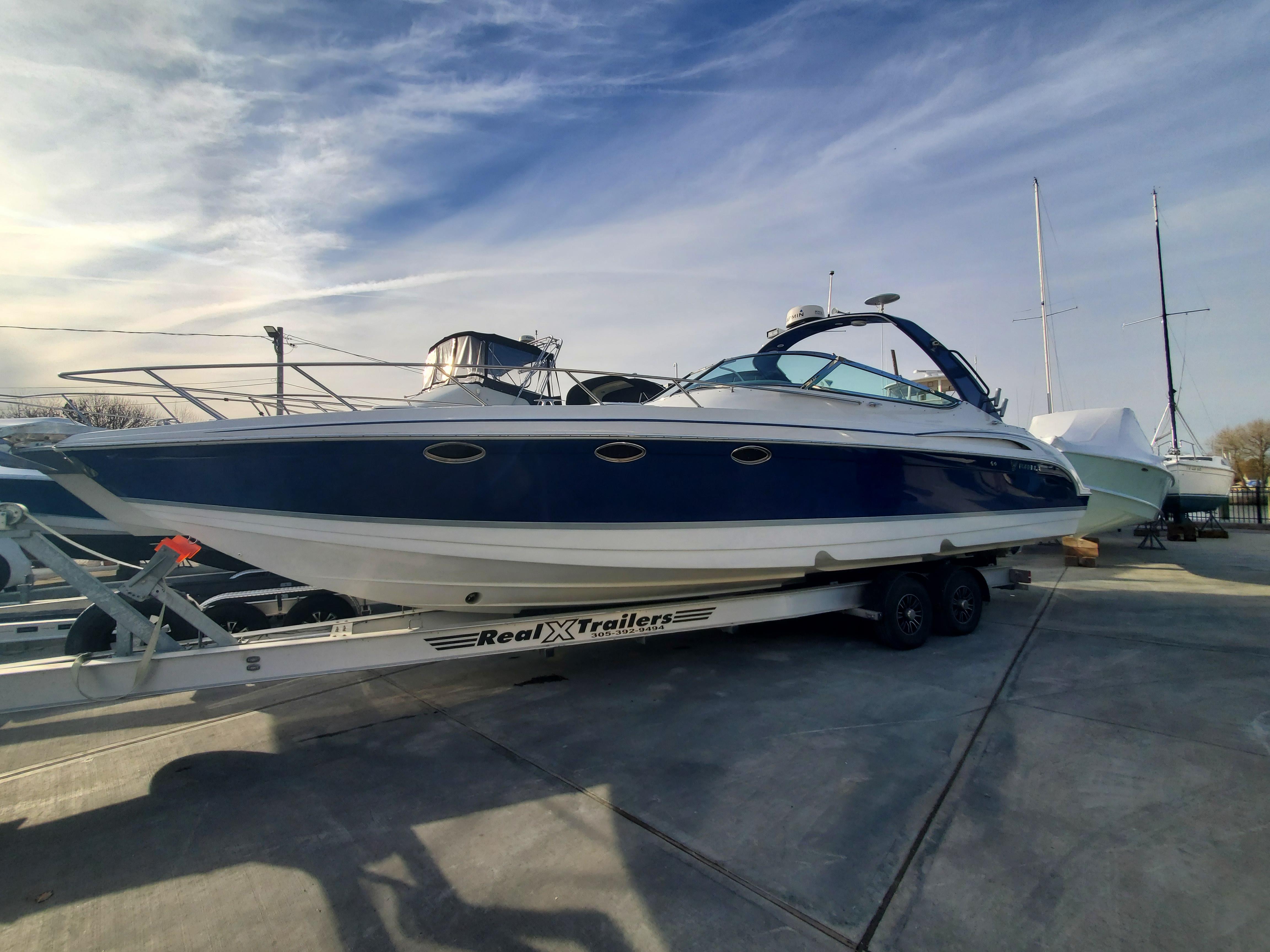 2004 Formula 370 Super Sport boat on trailer under clear sky.