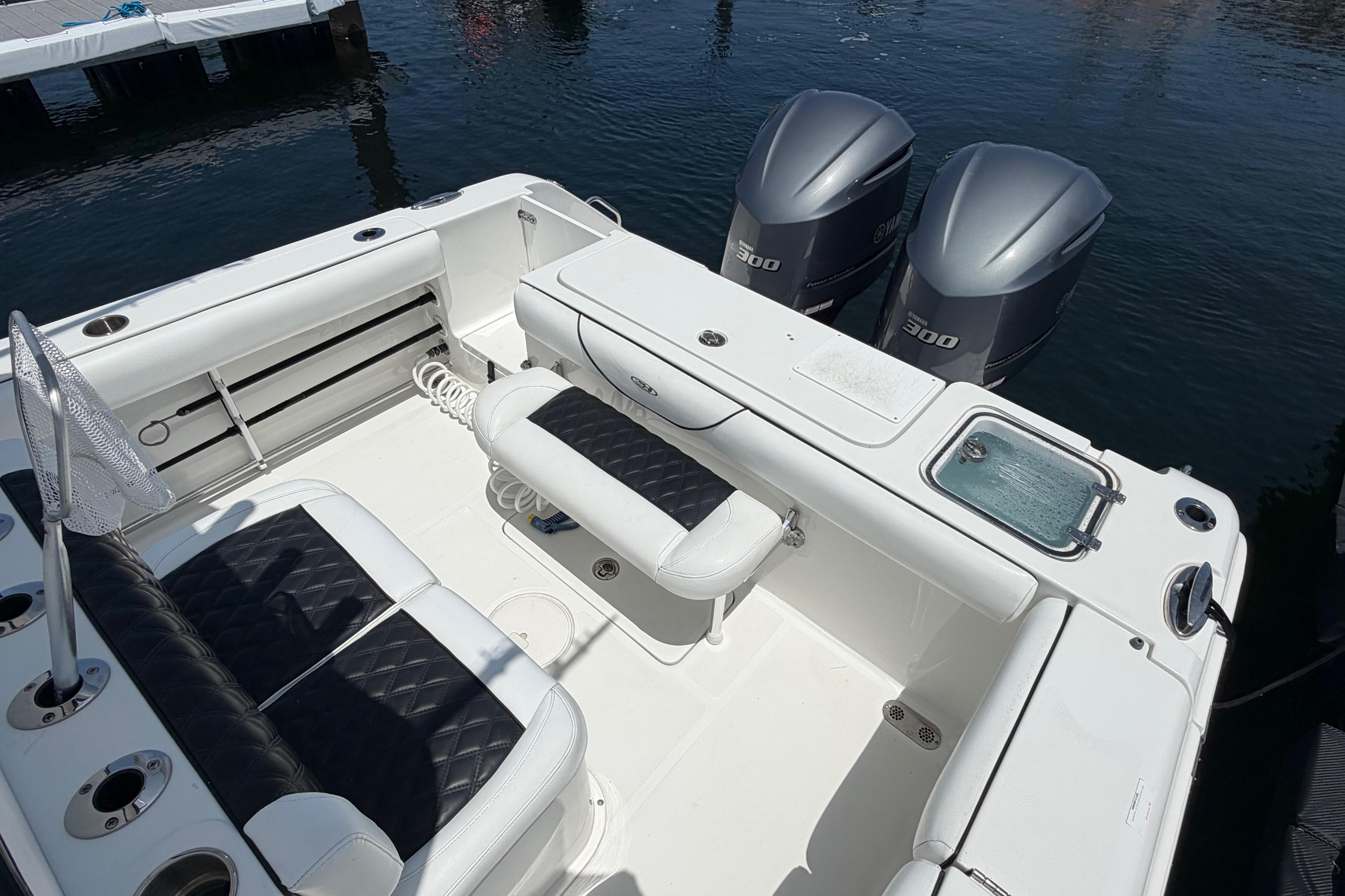 2019 Sea Hunt Gamefish 27 Coffin Box boat interior with twin engines and seating.