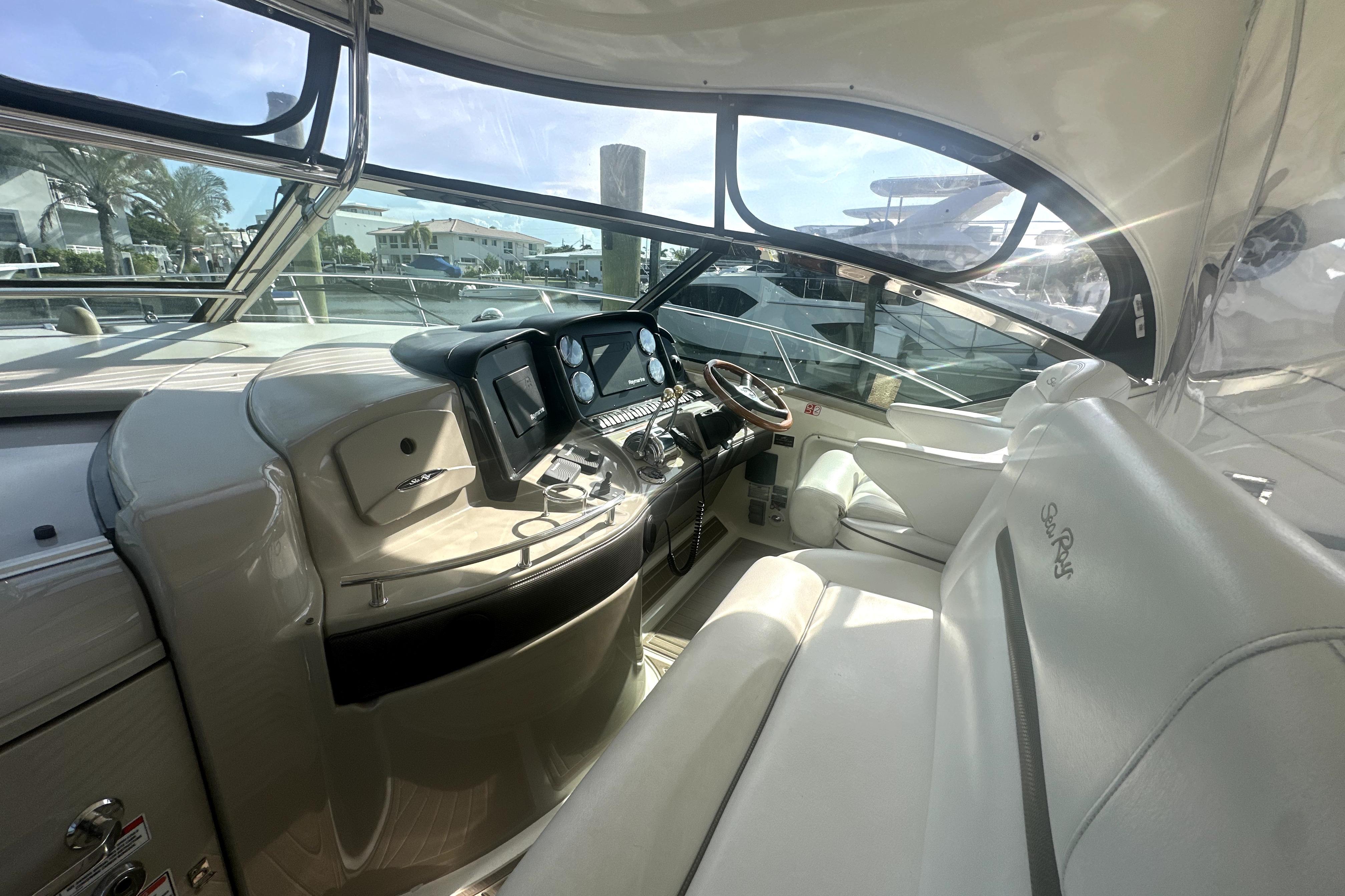 Interior of a 2007 Sea Ray 44 Sundancer yacht, featuring a sleek helm and luxurious seating.