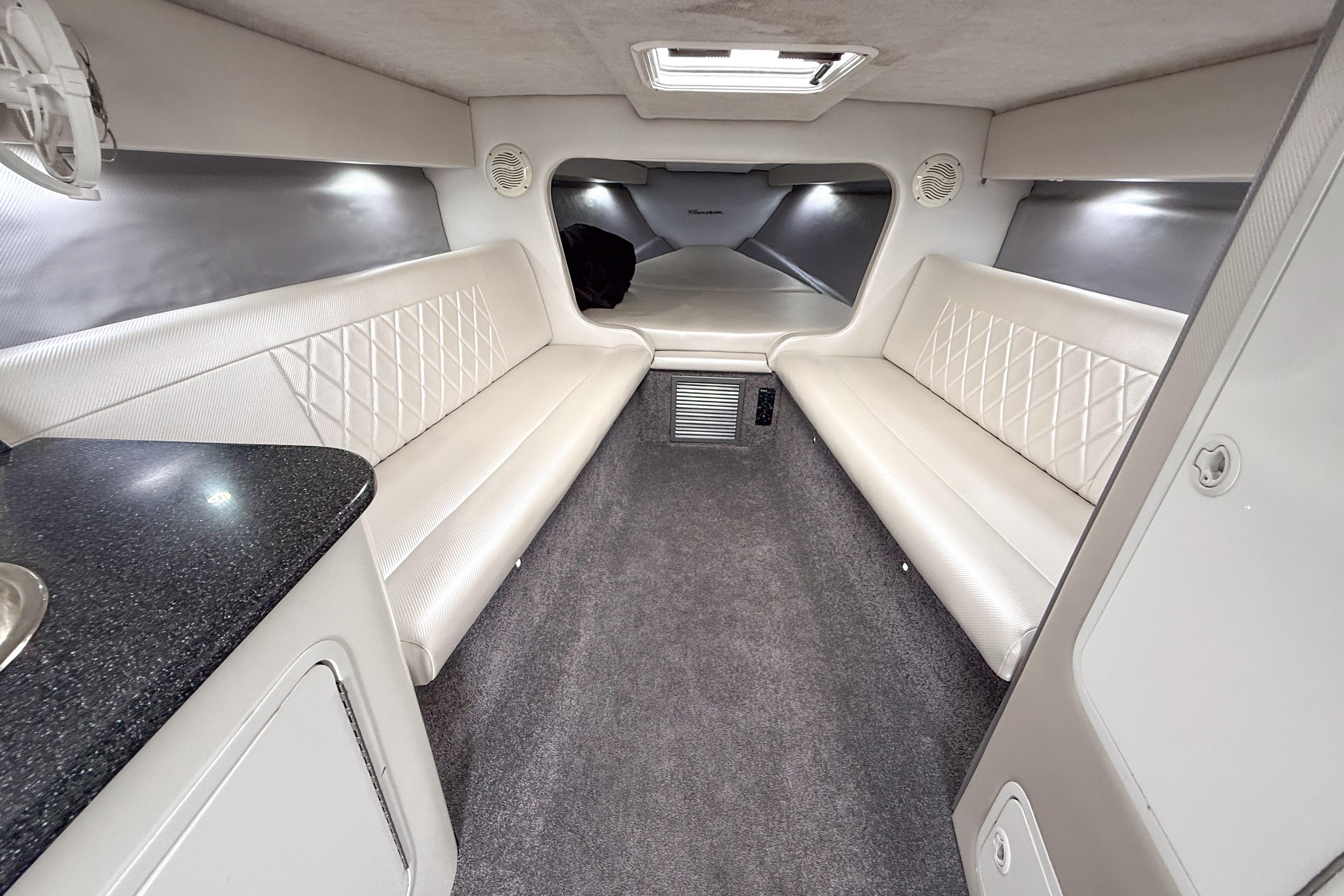 Interior of a 2002 Active Thunder 37 boat with white seating and modern design.