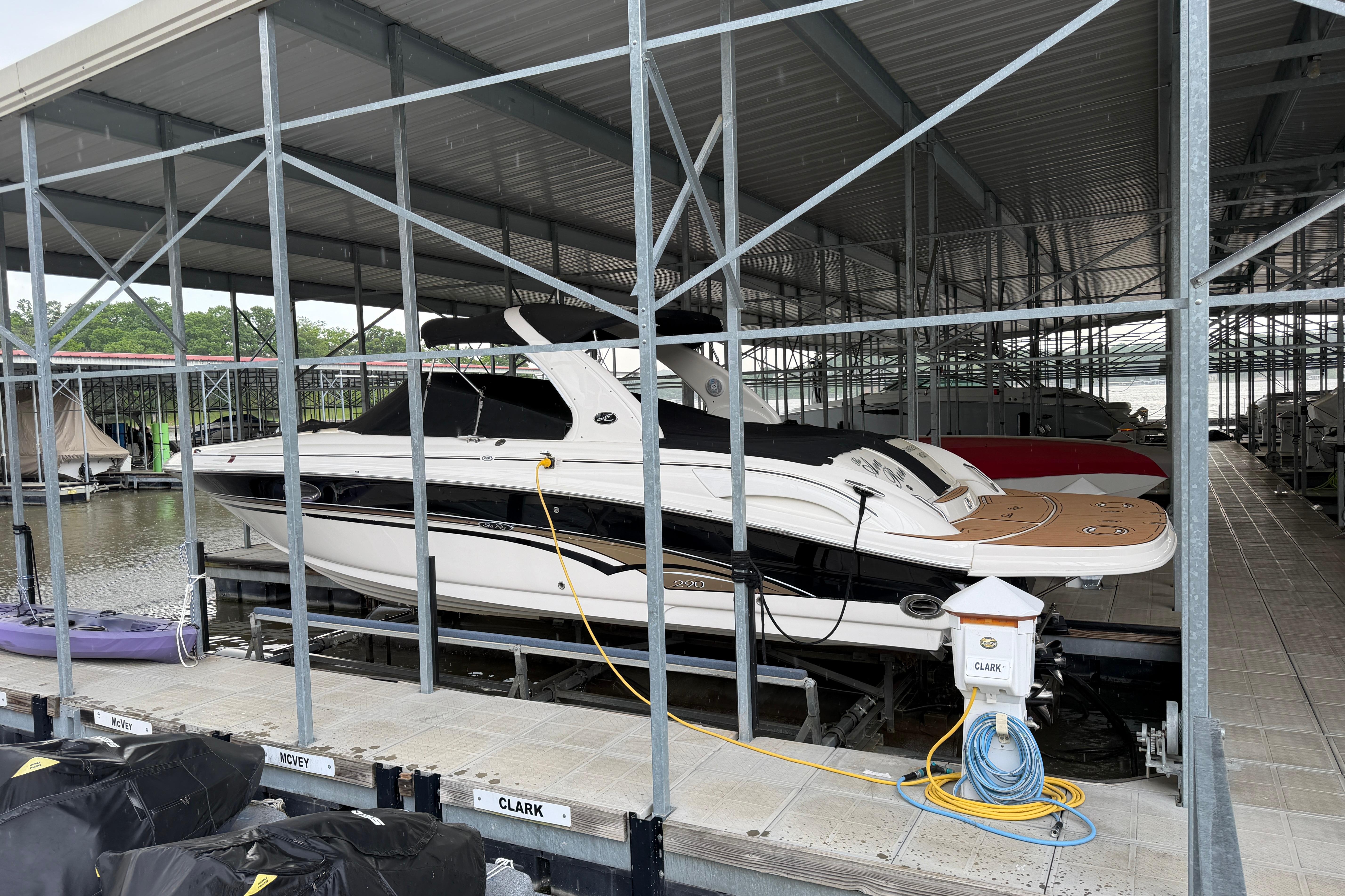 2003 Sea Ray 290 Bowrider docked in a covered marina slip.