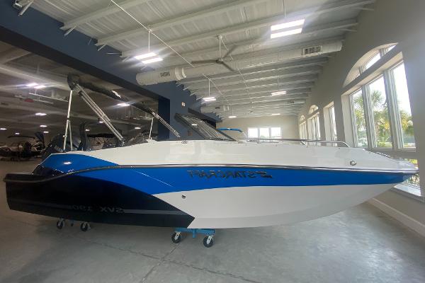 2024 Starcraft SVX 190 boat displayed indoors with blue and white exterior.