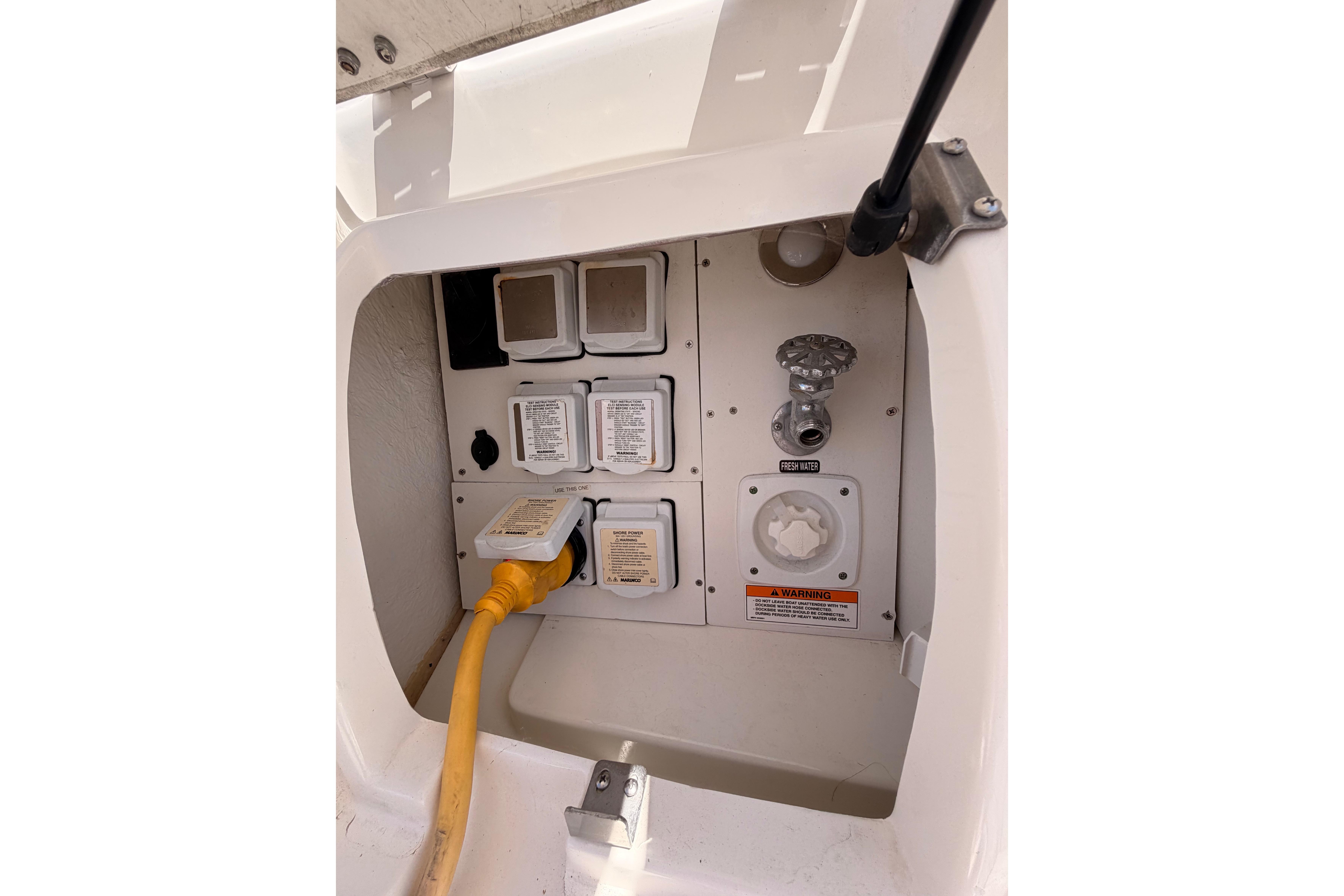 Electrical and water connections on a 2018 Sea Ray Sundancer 350 Coupe boat.