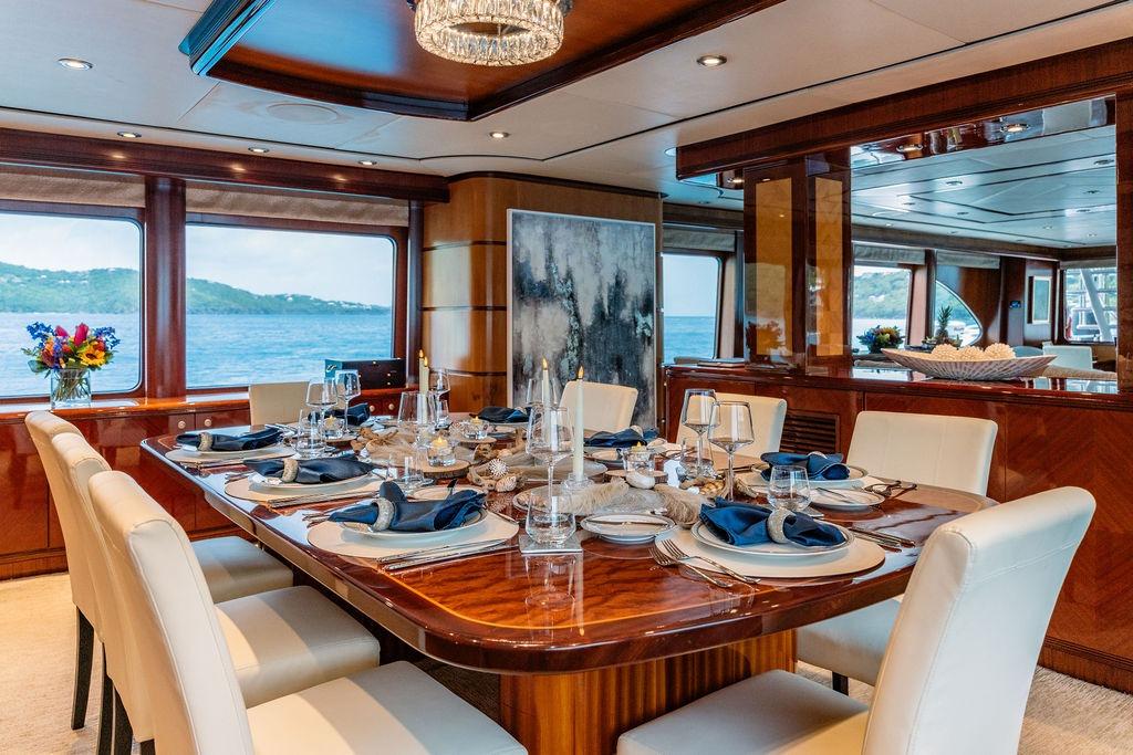 Luxurious dining area on 2012 Ares Custom Marine Custom 141 yacht with elegant table setting.