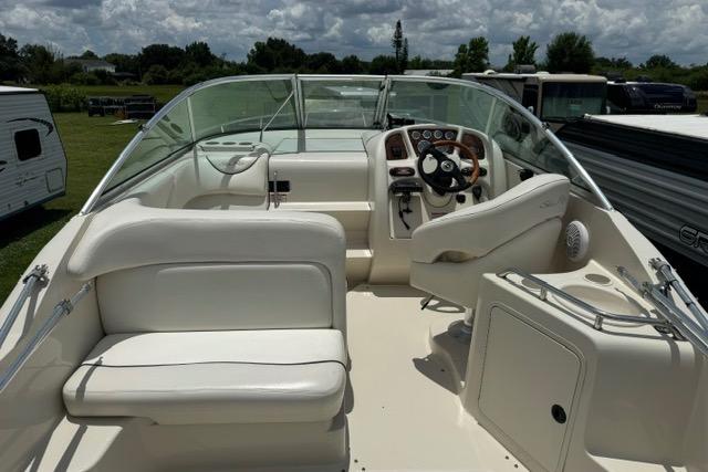 2004 Sea Ray 240 Sundancer boat interior with steering wheel and seating.