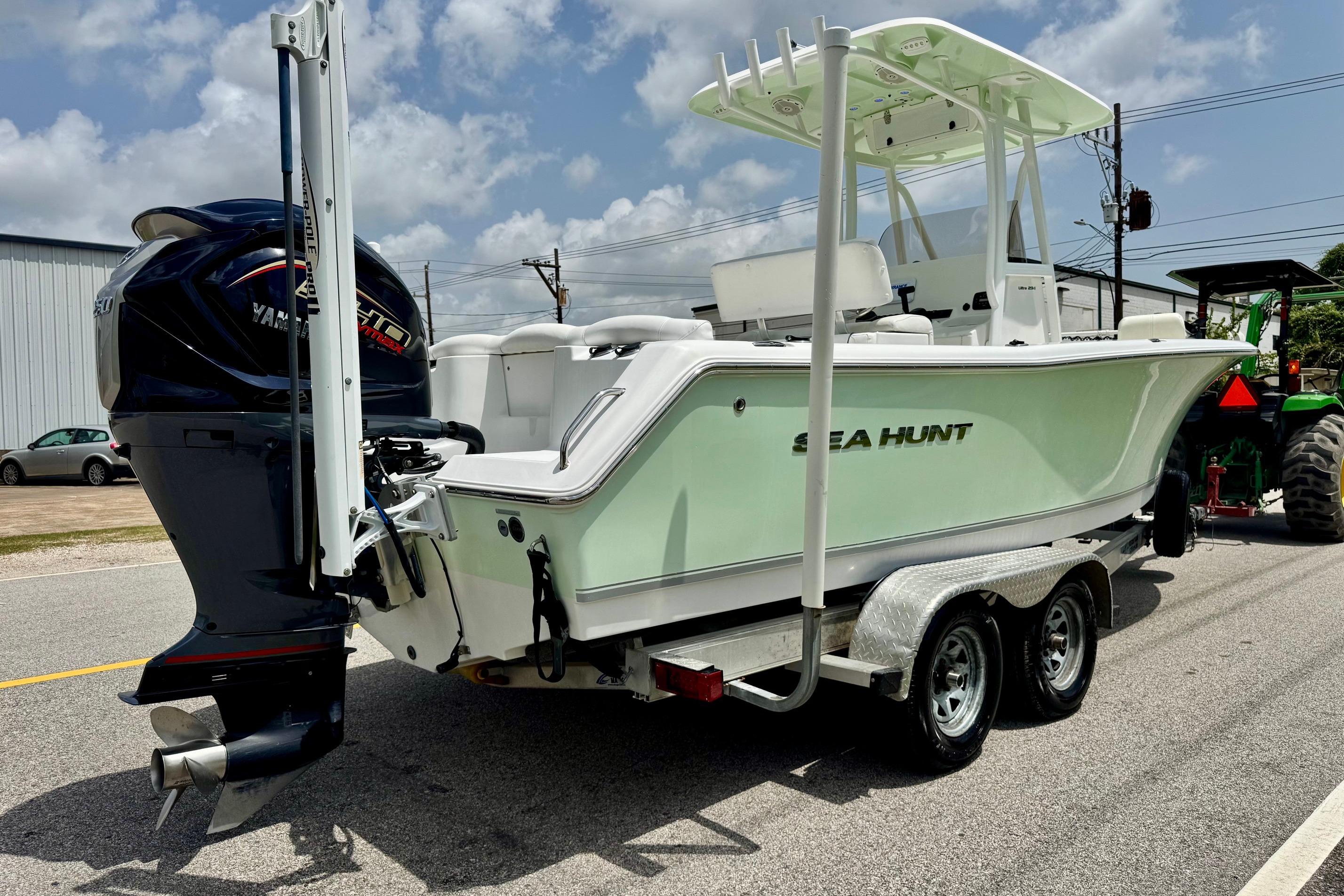 2015 Sea Hunt Ultra 234 boat on trailer with Yamaha engine, parked outdoors.