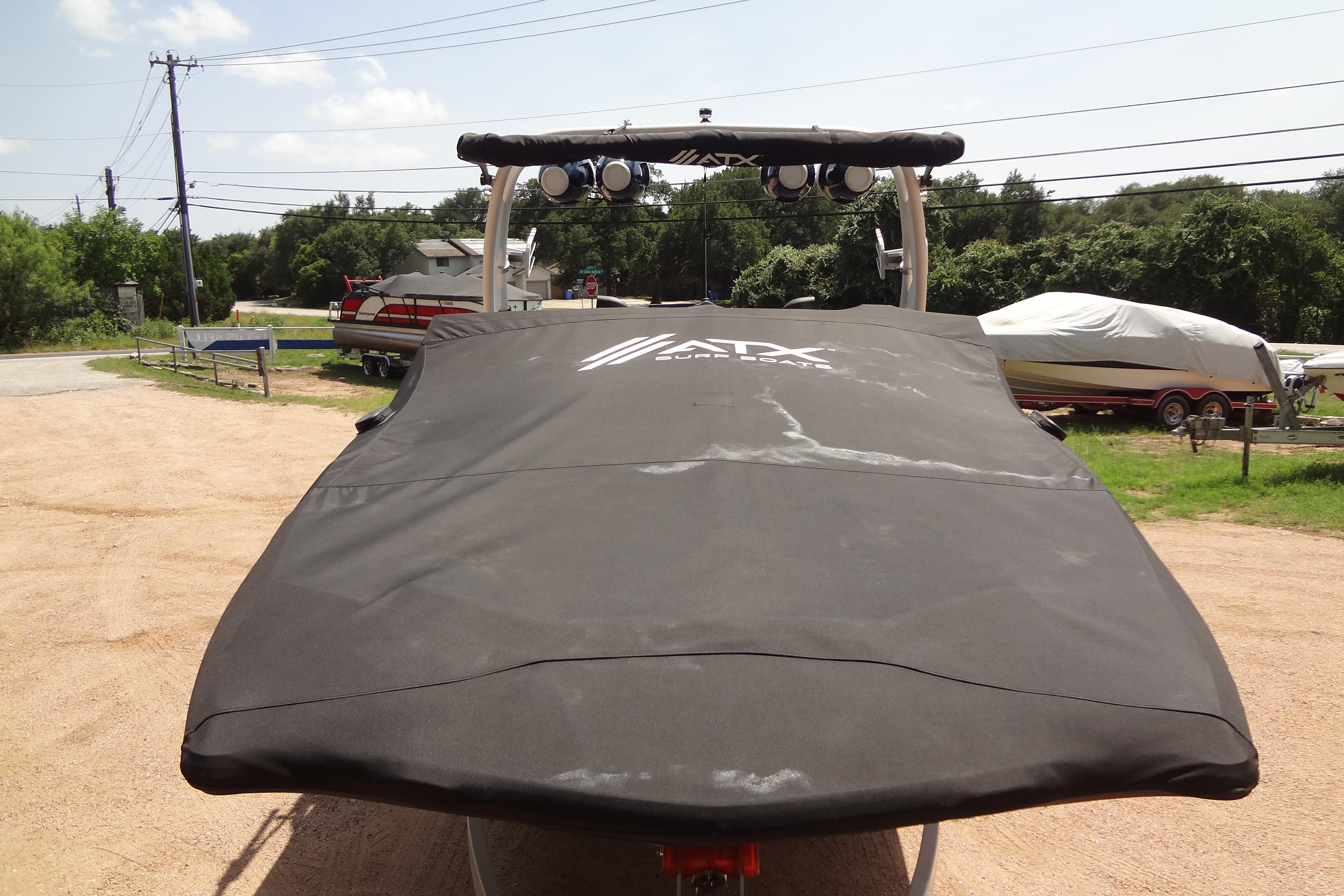 2022 ATX Surf Boats 24 Type-S covered, parked outdoors on a sunny day.