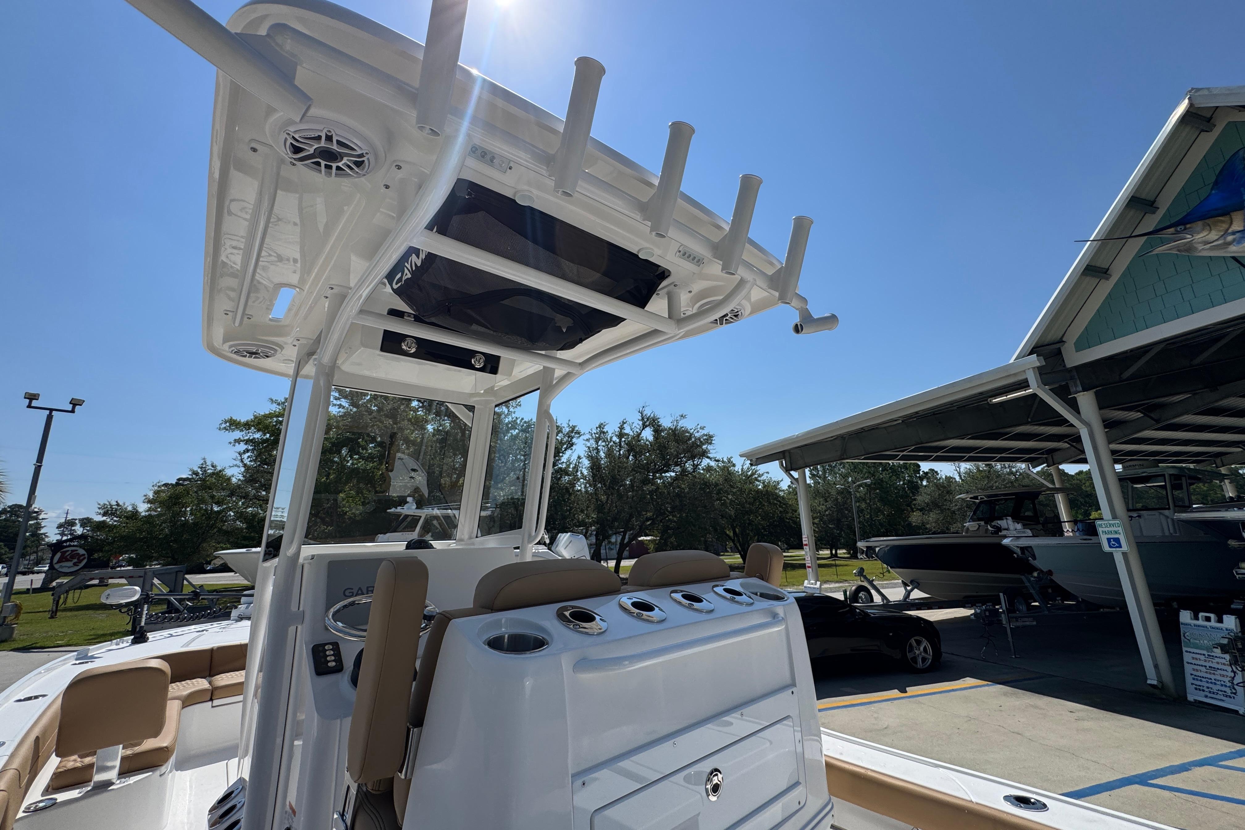 2027 Caymas 26 HB boat with T-top and rod holders, displayed outdoors.