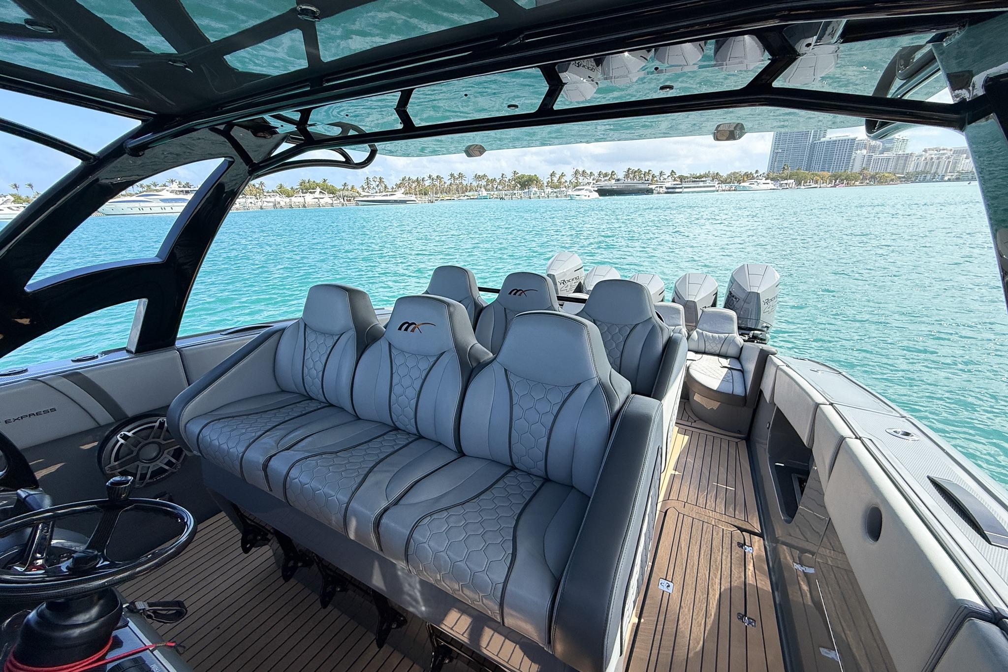 2023 Midnight Express 43 Solstice luxury boat interior with plush seating on turquoise waters.