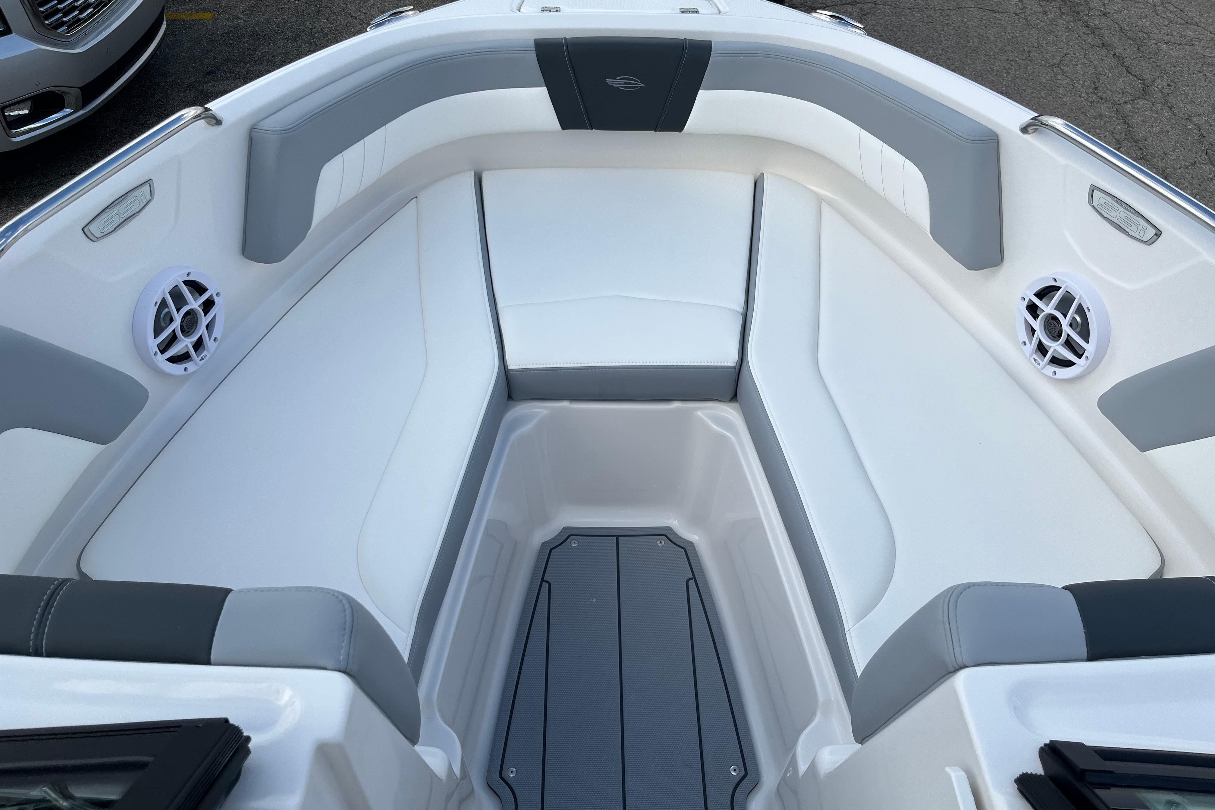 2026 Chaparral 21 SSi boat interior with white and gray seating and speakers.