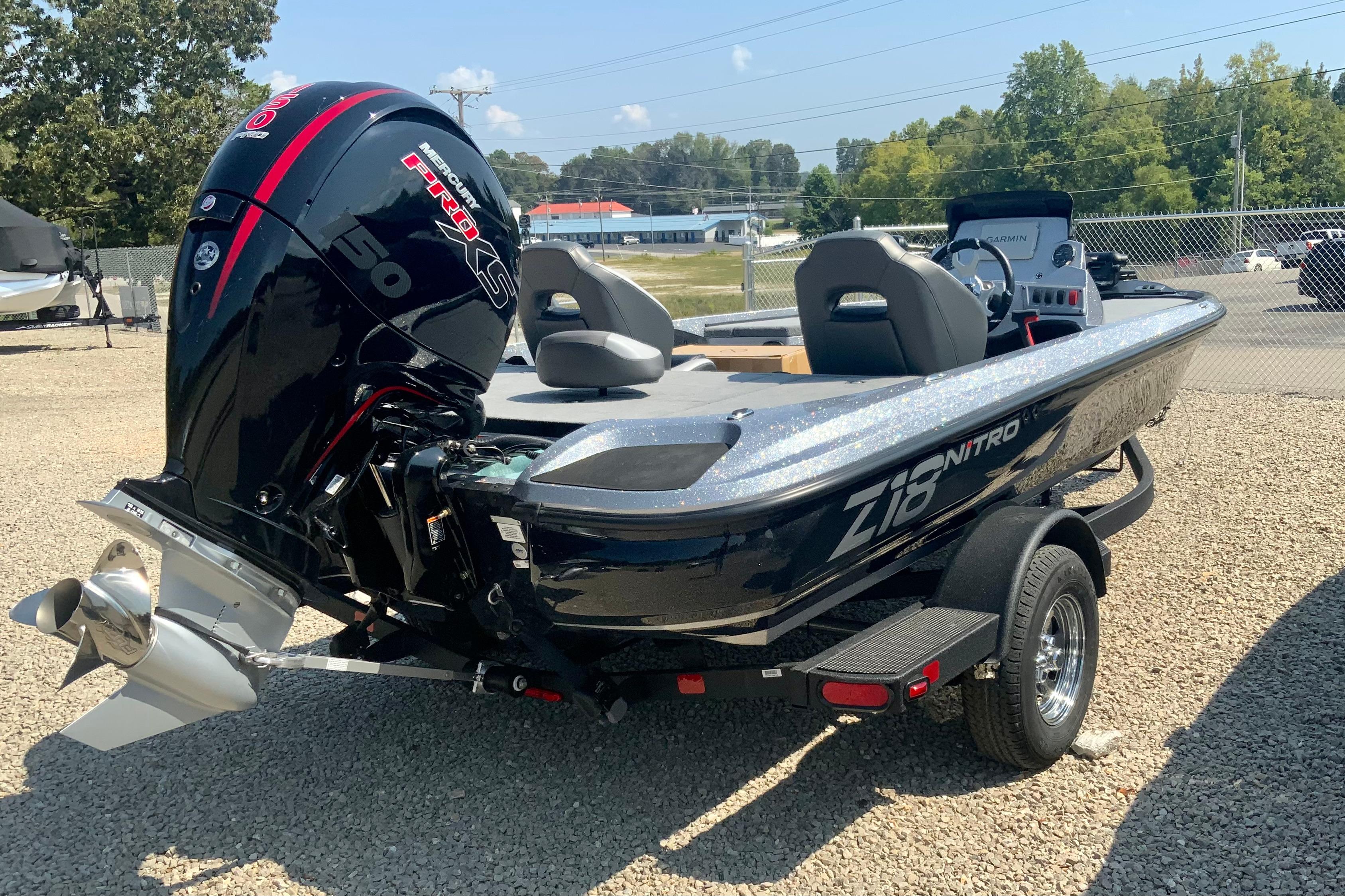 2026 Nitro Z18 Pro boat with powerful engine, parked on gravel lot.
