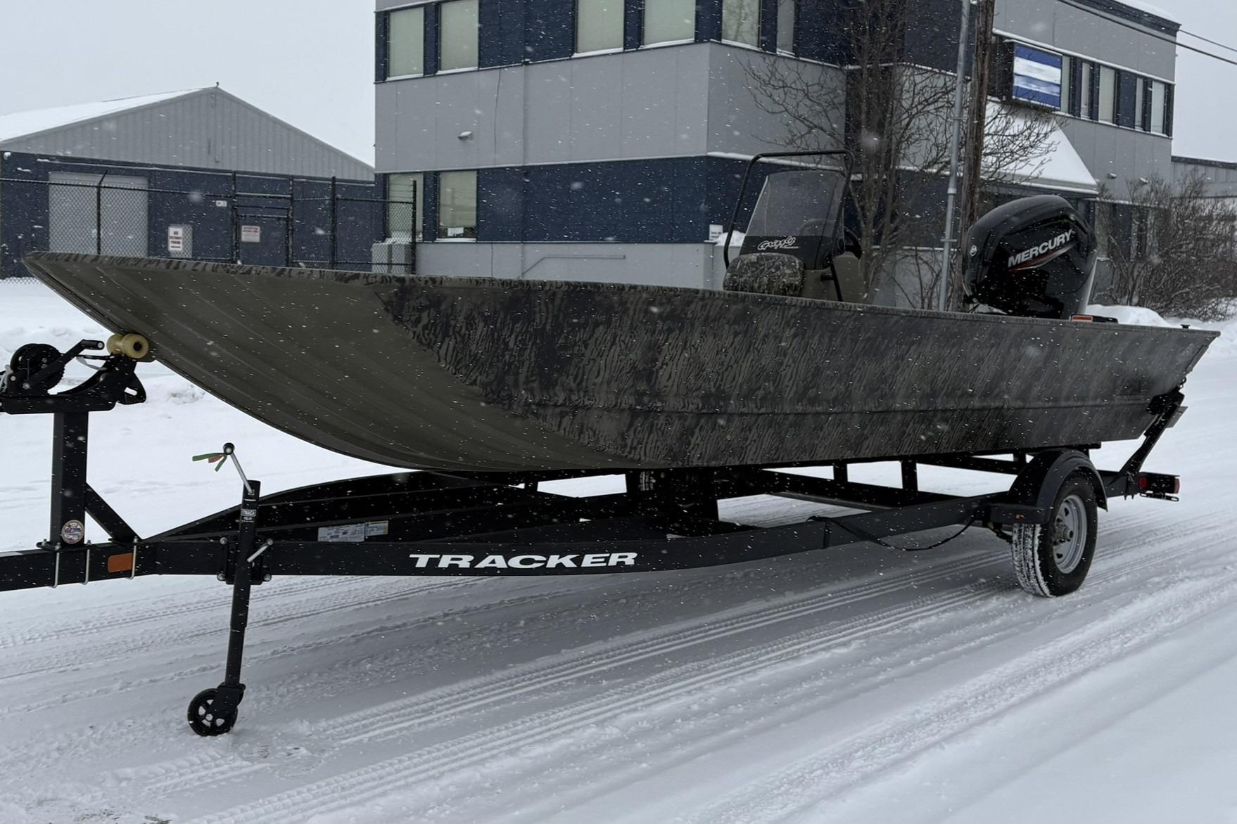 2025 Tracker Grizzly 2072 CC boat on trailer in snowy setting.