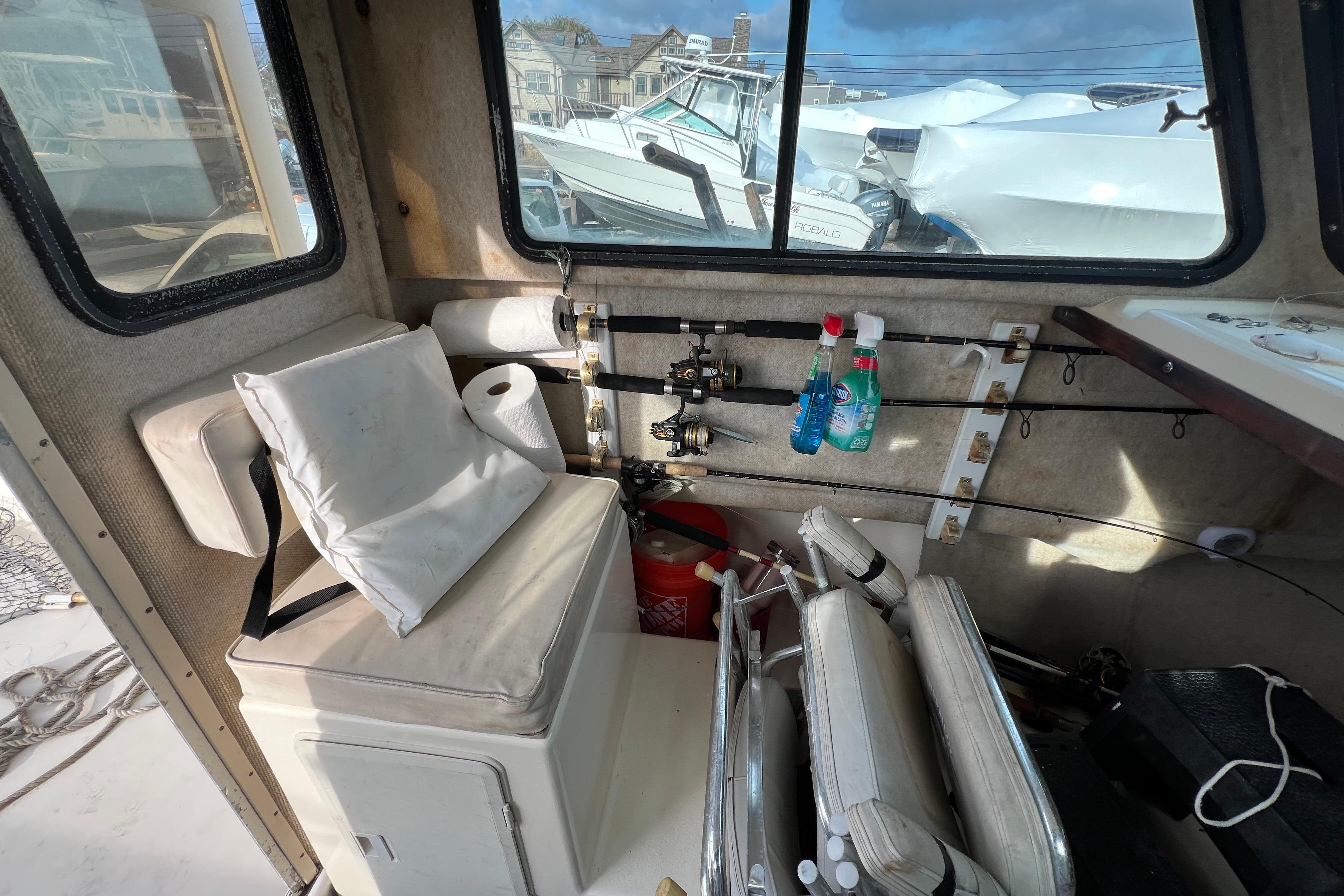 Interior of 2001 Parker 2520 Deep Vee Sport Cabin with fishing gear and seating.