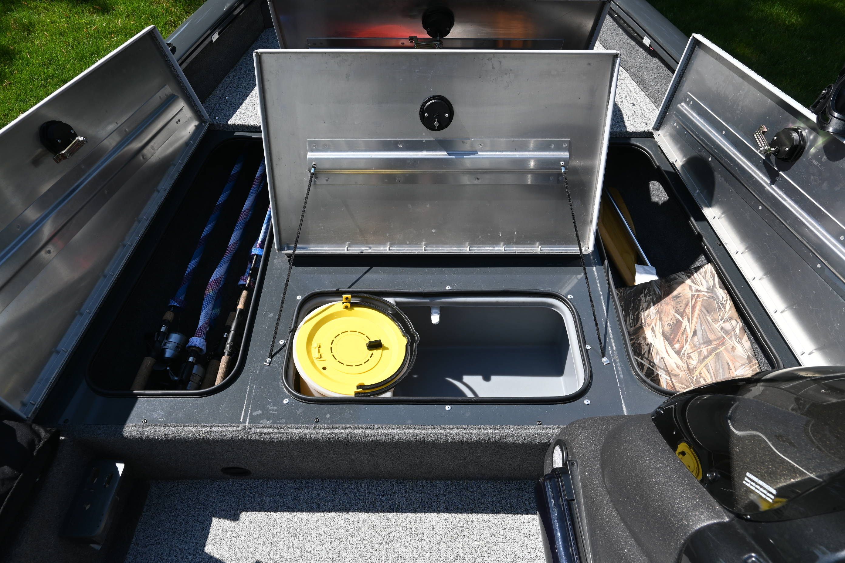 Interior view of a Tracker Pro 175 TF boat with storage compartments and equipment.