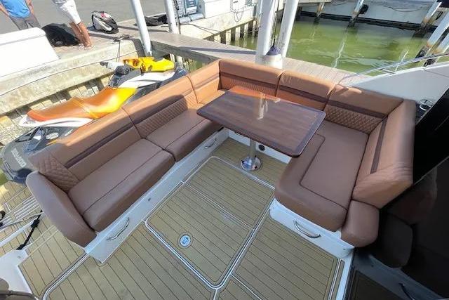 Luxurious seating area on 2016 Sea Ray Sundancer 510 yacht with elegant wood table.
