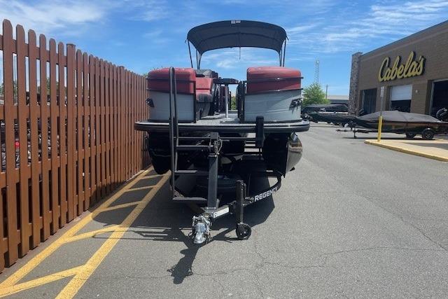 2026 Regency 250 DL pontoon boat parked outside Cabela's store.