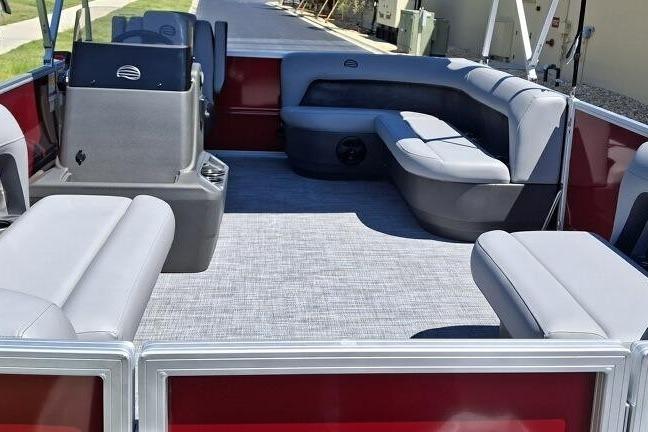 2026 Sun Tracker Party Barge 16 DLX interior with gray seating and red accents.