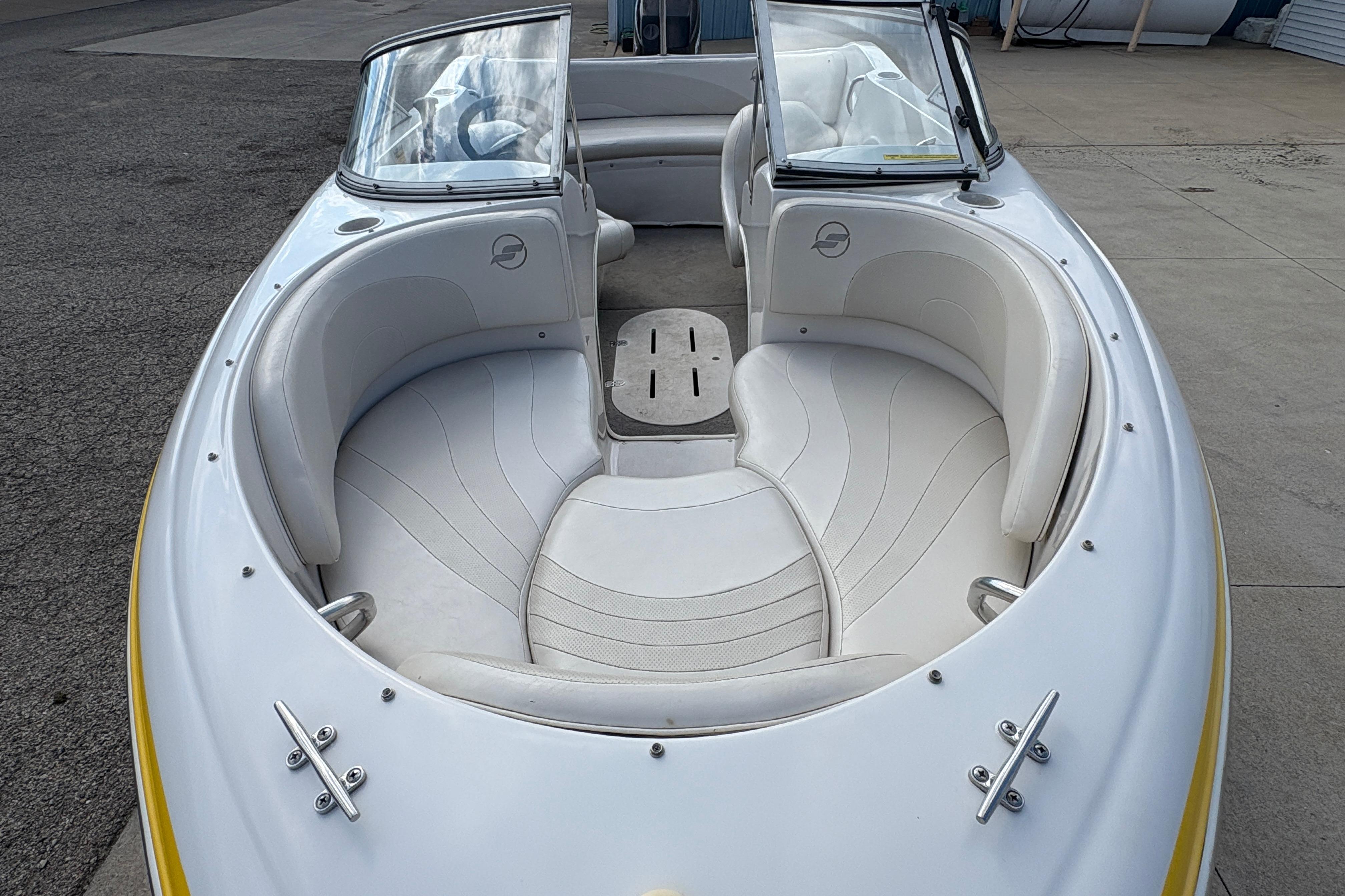 2005 Starcraft C-Star 1700 OB boat with white seating and open bow design.