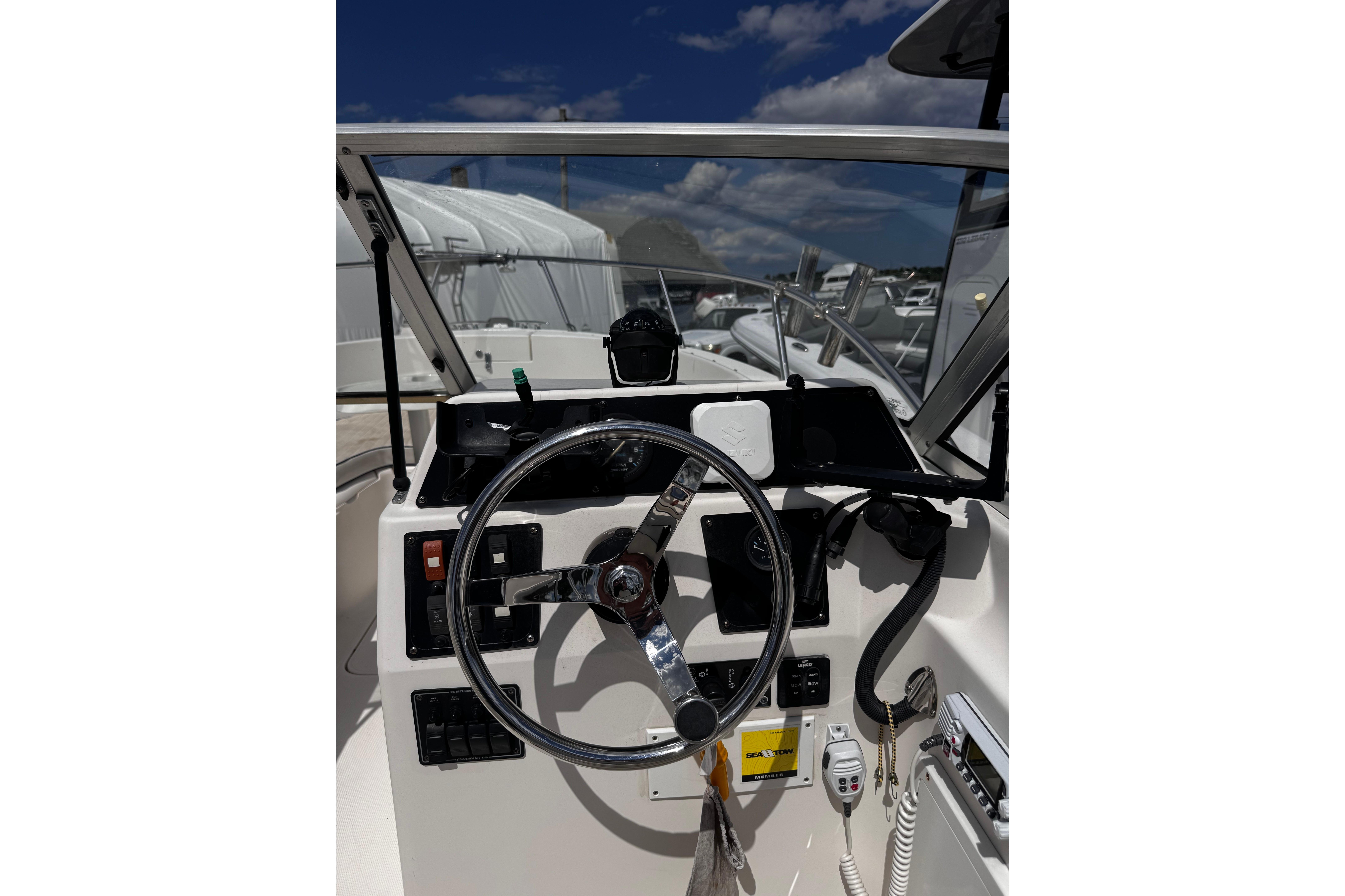 2003 Palm Beach 2200 Dual Console boat dashboard with steering wheel and controls.