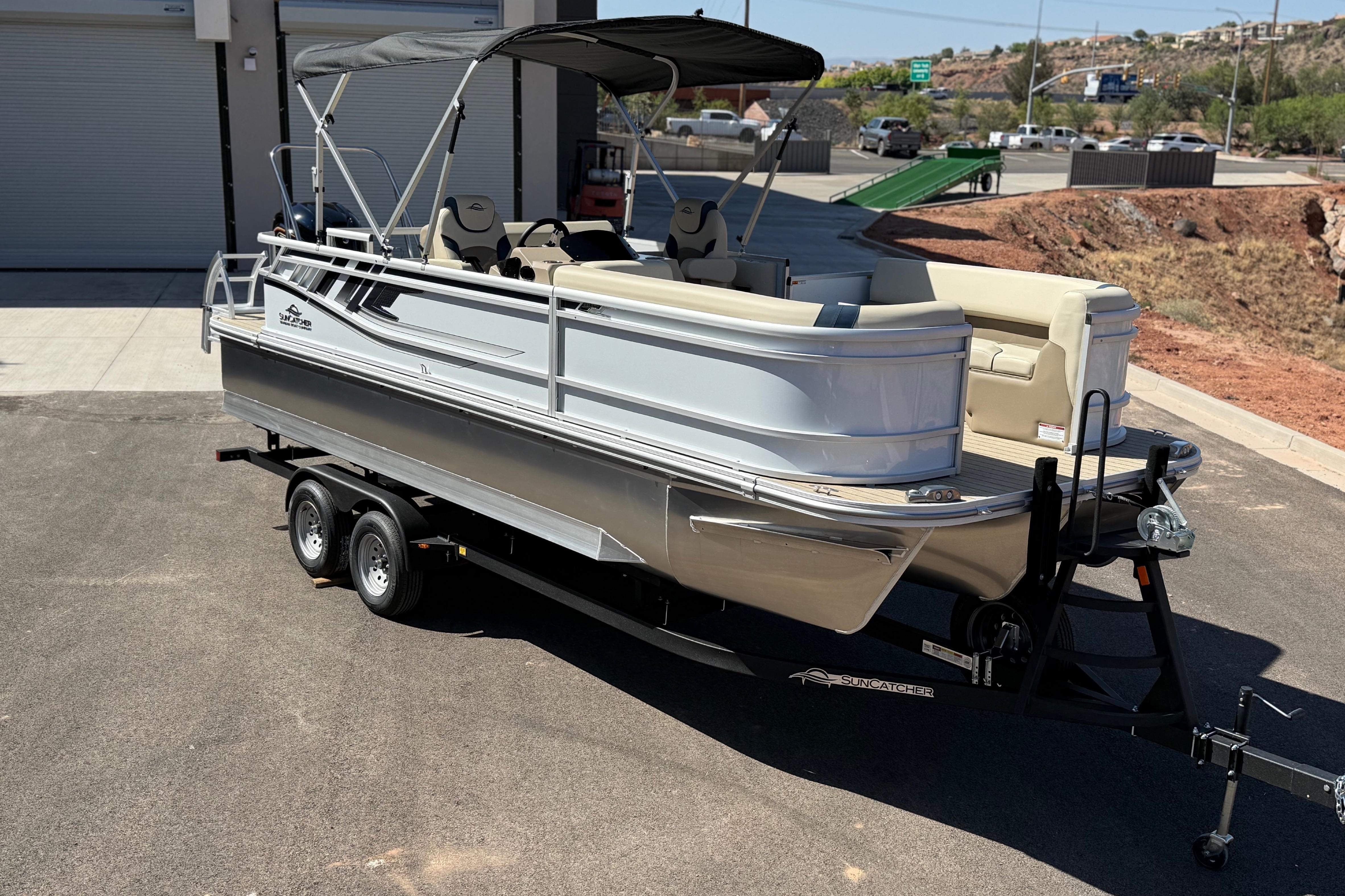 2026 SunCatcher Select 322SL pontoon boat on trailer, parked outdoors.