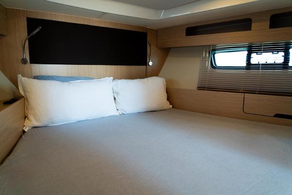 Interior cabin of 2022 Bavaria SR41 yacht with cozy bed and modern design.