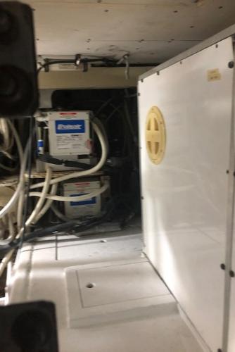 Engine room of a 1997 Bertram Convertible boat with electrical systems.