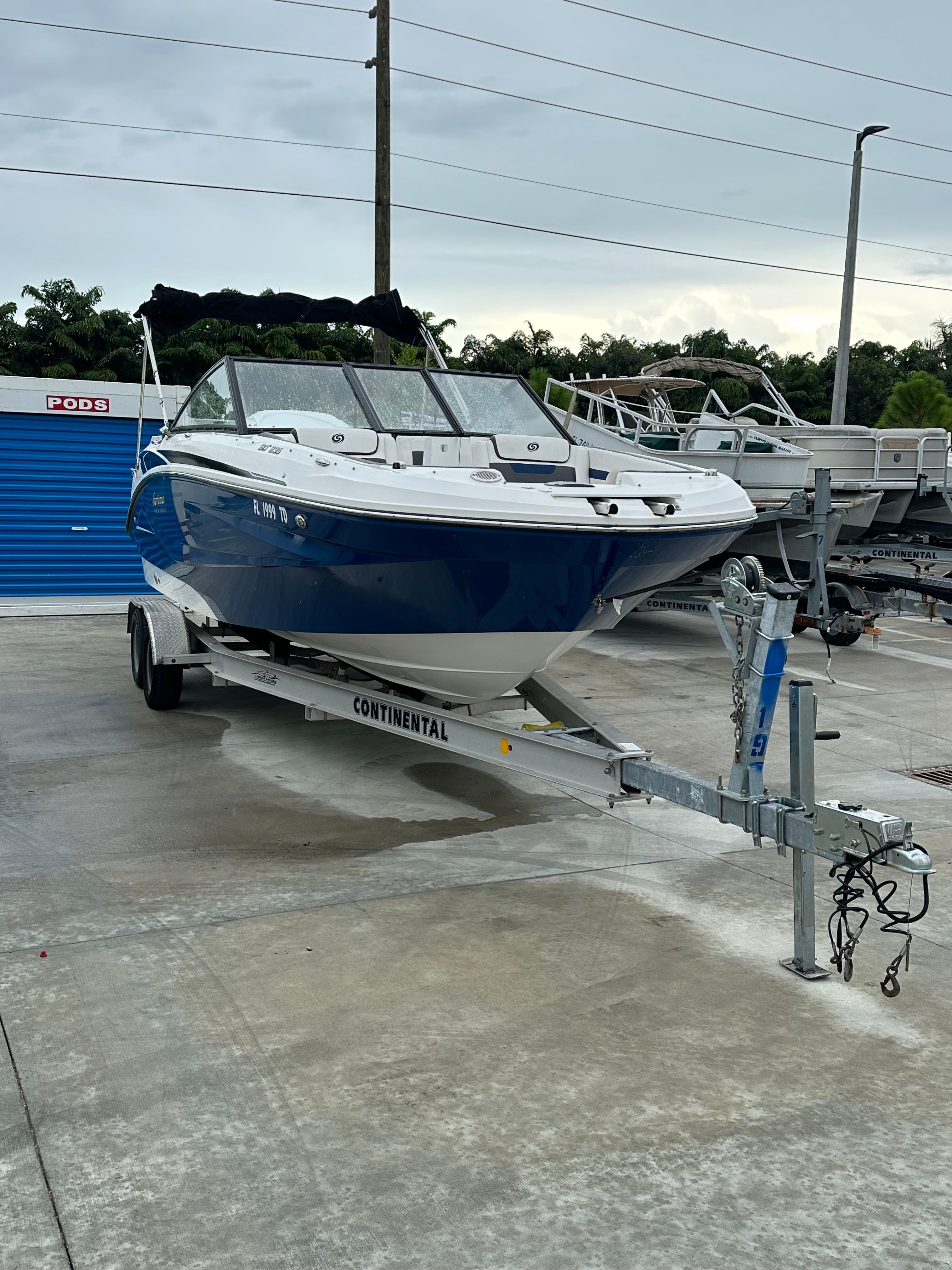 2022 Hurricane 235SD boat parked on trailer outdoors.