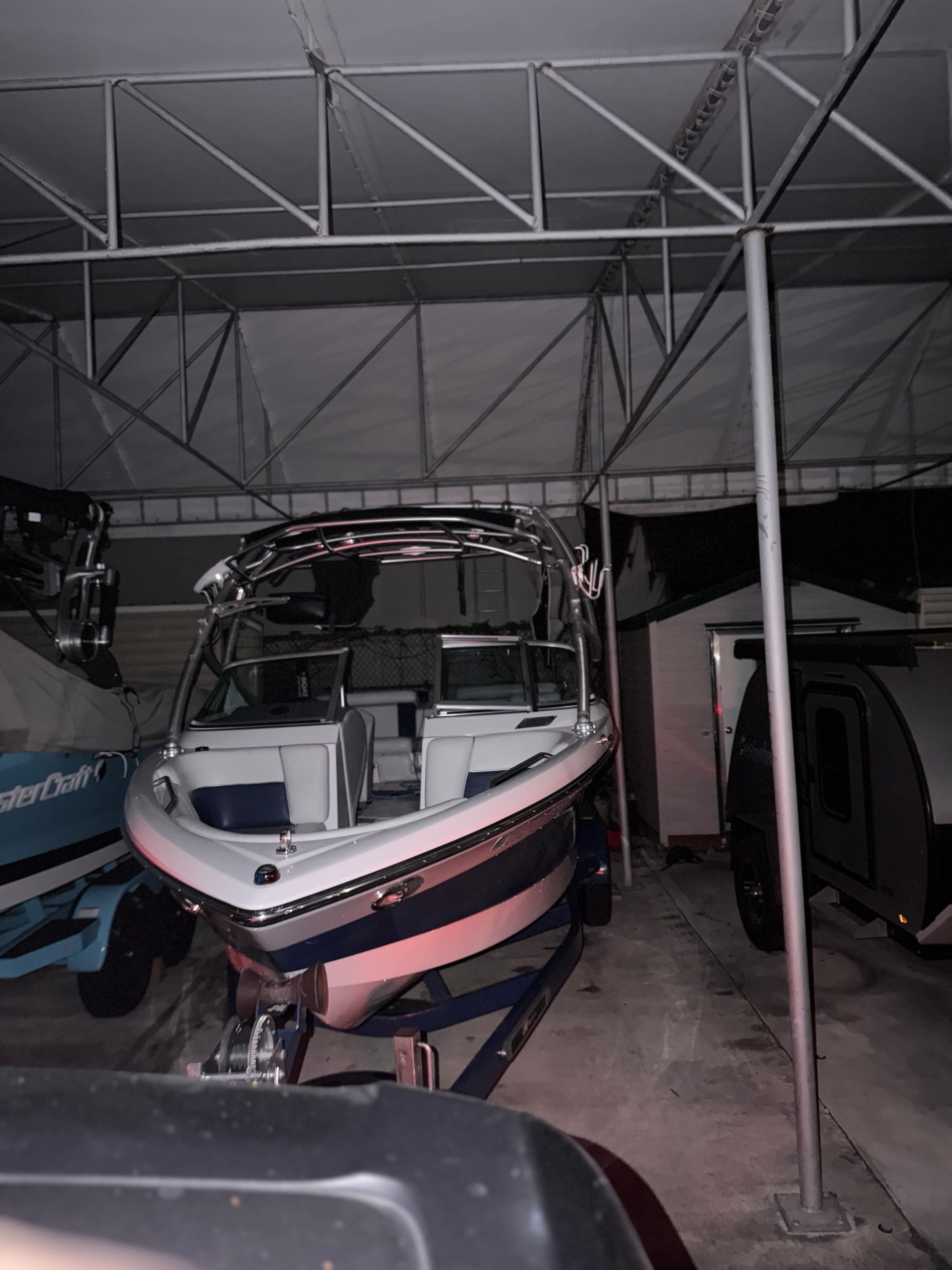 2008 Nautique 236 Team Edition boat under a carport.