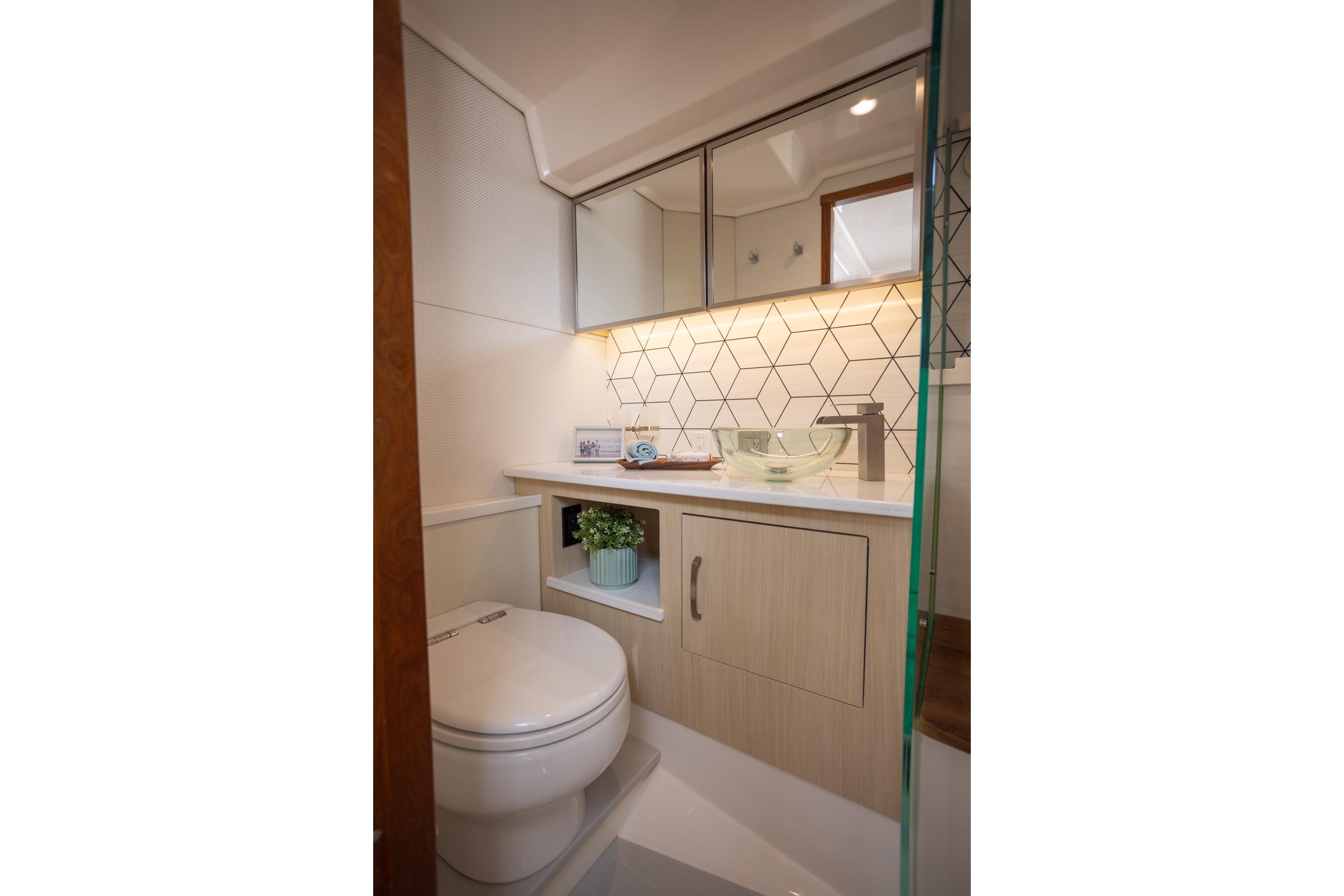 Modern bathroom in 2026 Regal LX43 yacht with geometric tiles and sleek fixtures.