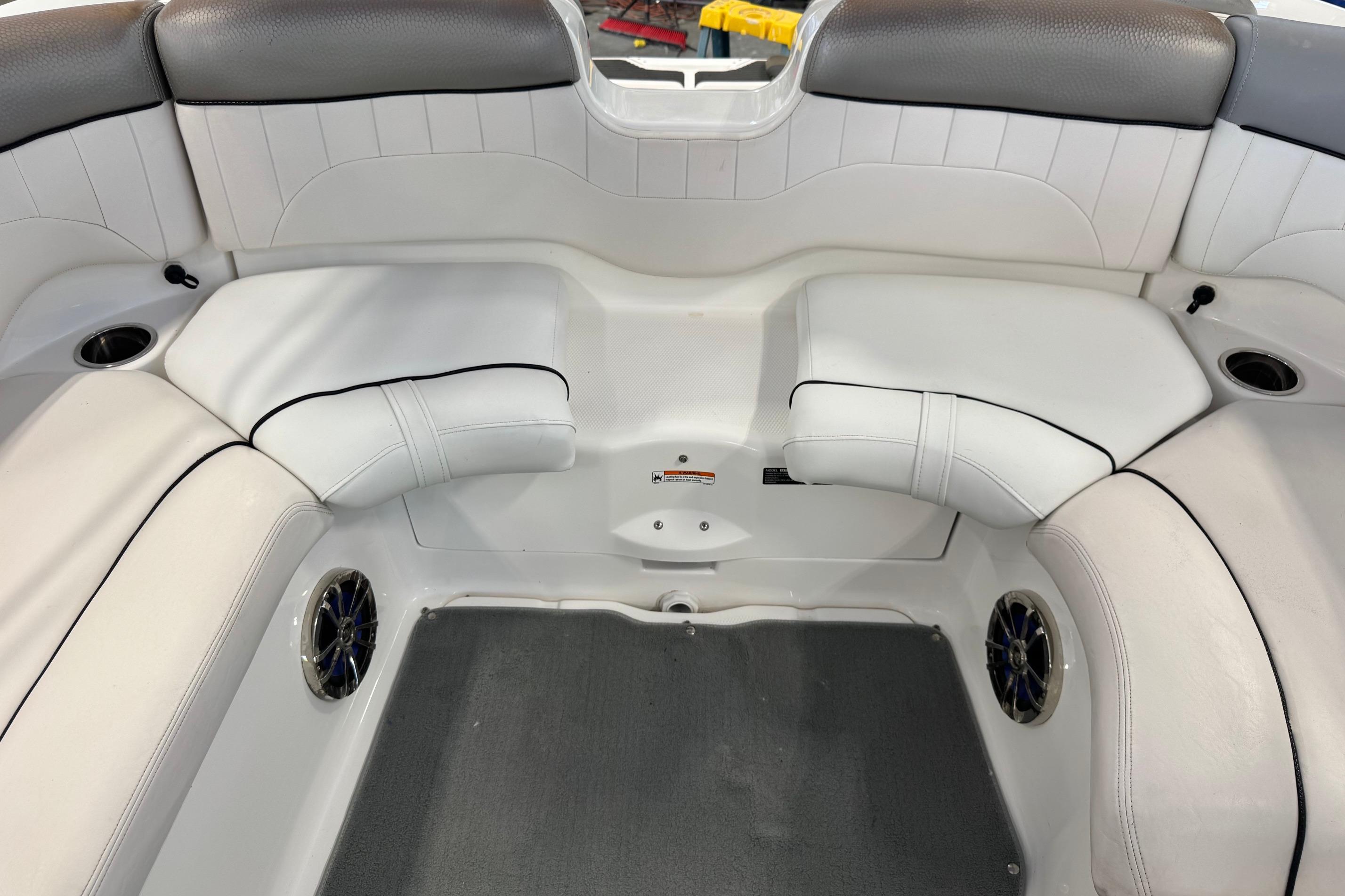 2007 Yamaha Boats SX230 HO interior seating with white upholstery and cup holders.