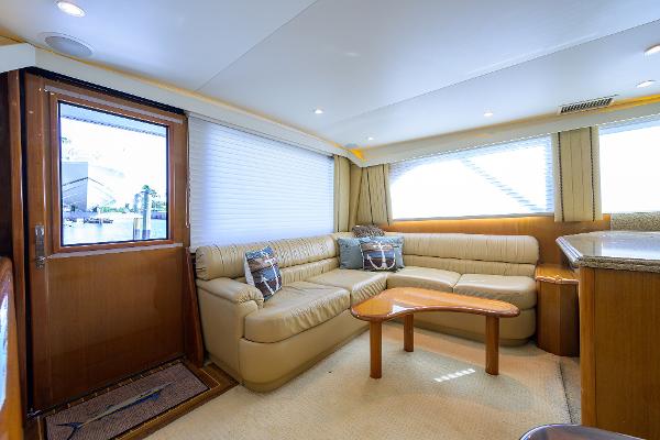 Luxurious interior of 2000 Viking 50 Convertible yacht with beige leather seating and wooden accents.