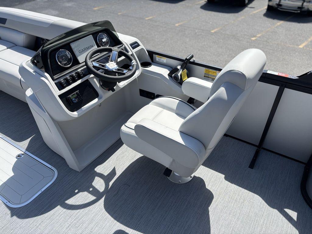 2026 Godfrey SWEETWATER 2286 SFL boat interior with steering console and seating.