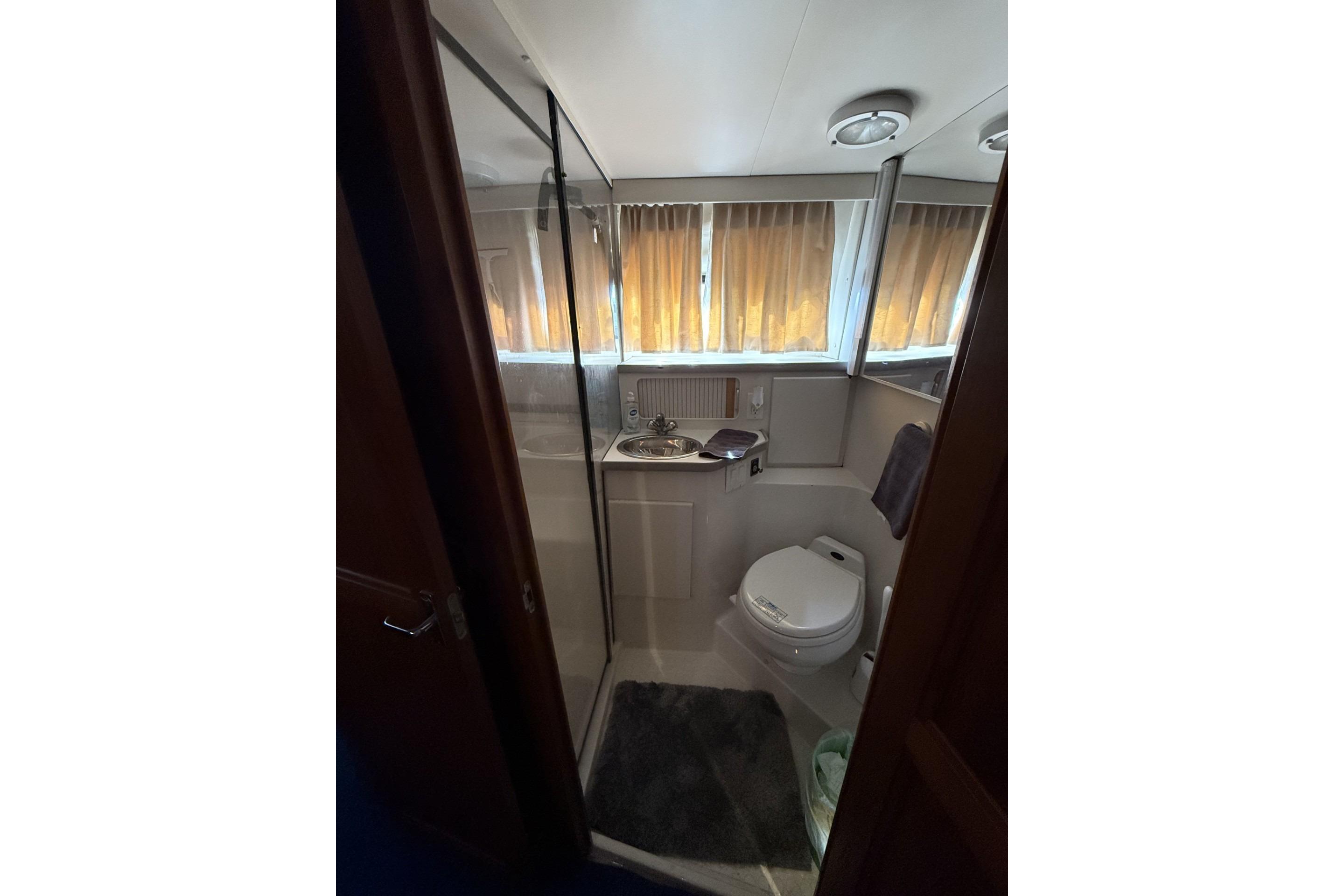 Bathroom interior of 1993 Carver 350 Motor Yacht with shower and toilet.