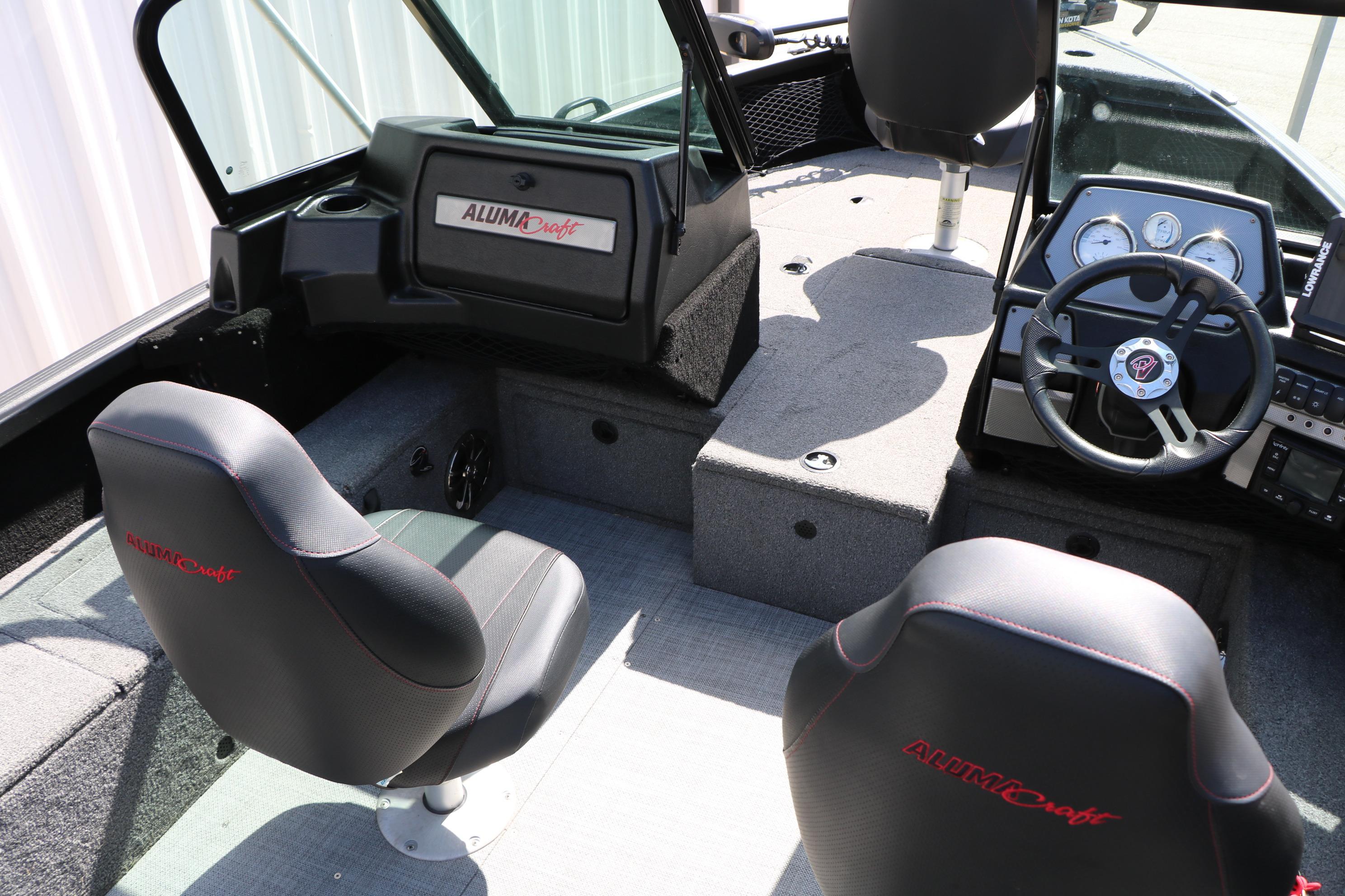 2023 Alumacraft Competitor FSX 185 boat interior with steering wheel and seating.