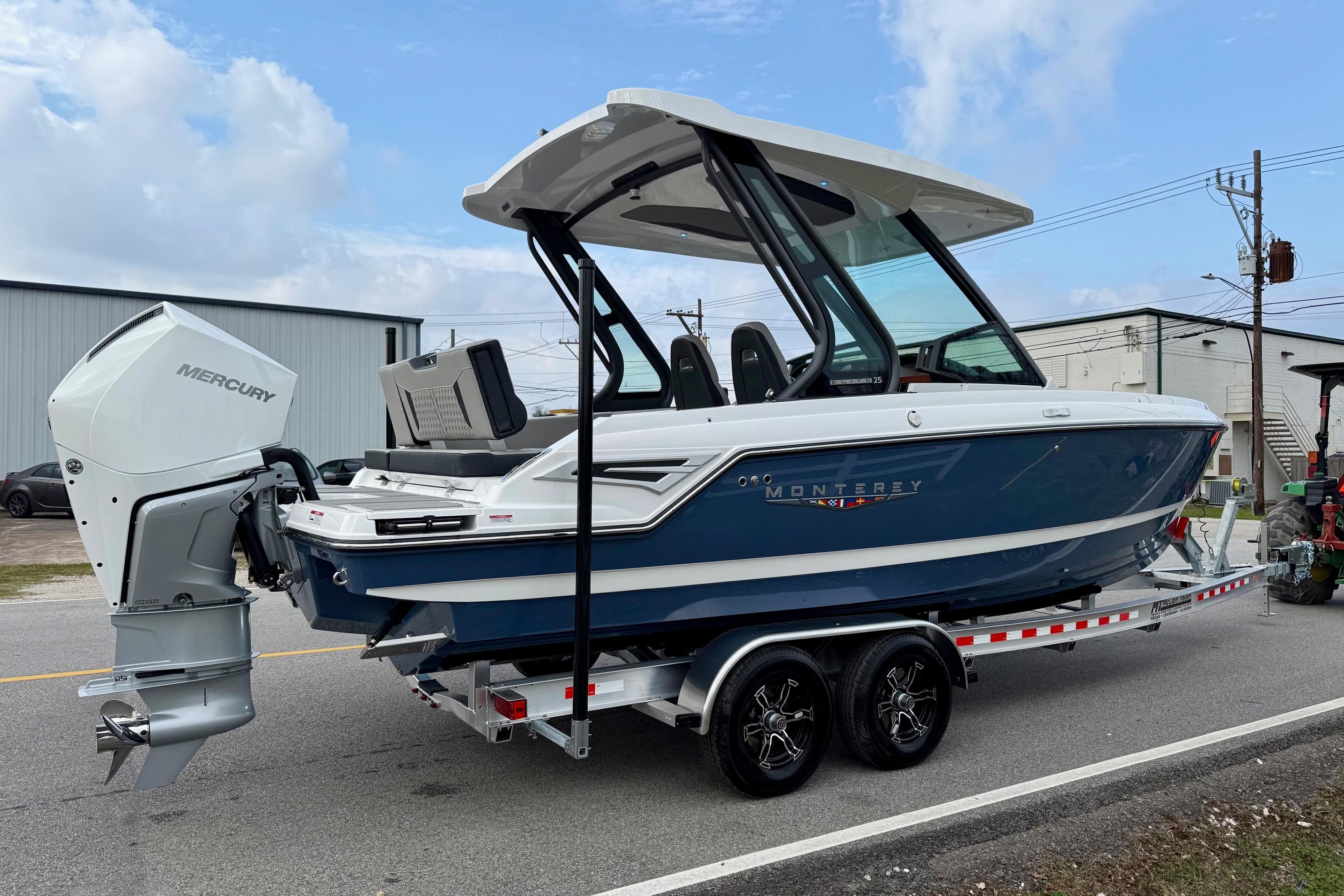 2026 Monterey Elite 25 OB boat on trailer with Mercury outboard motor.