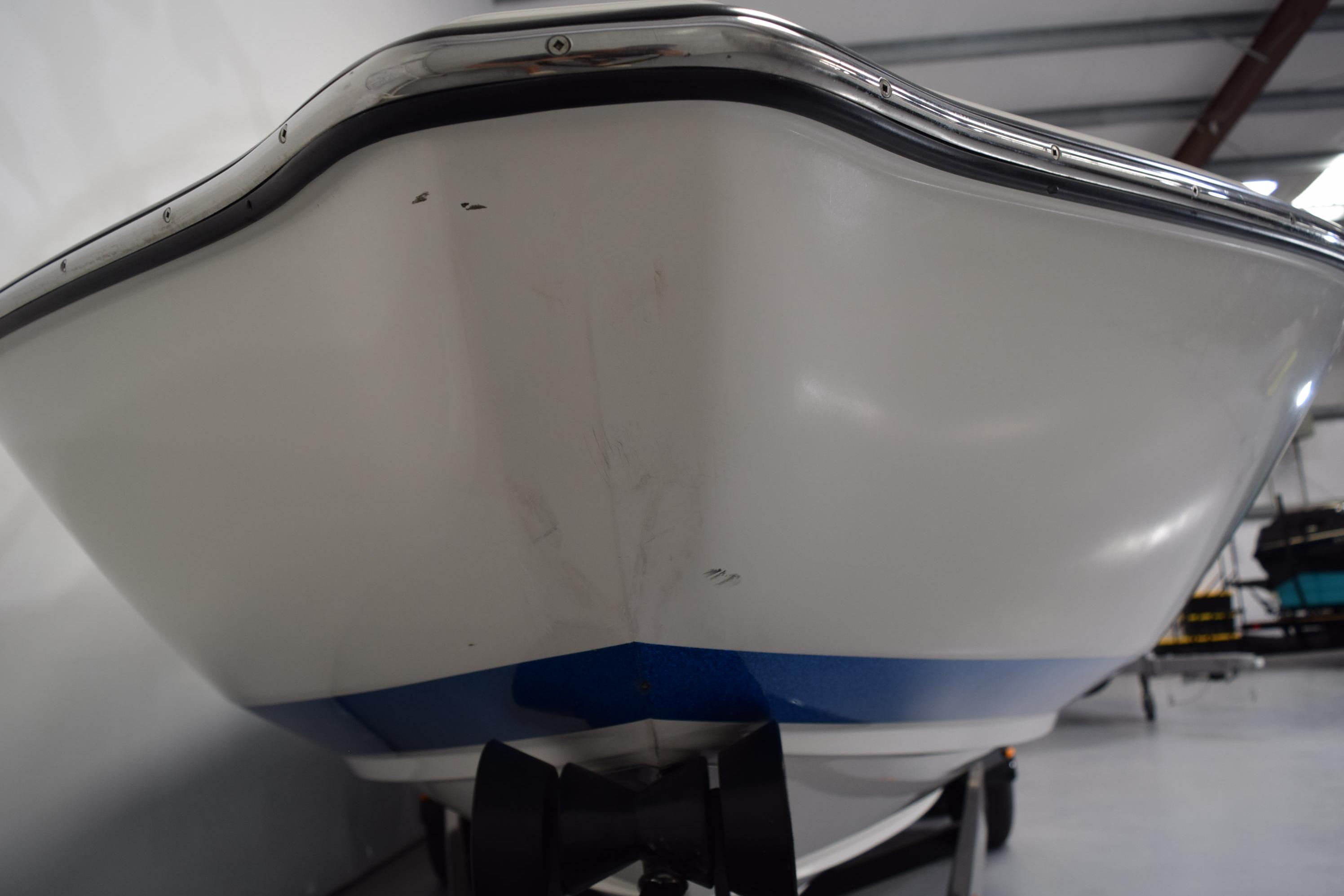 2007 Centurion SV 240 boat hull in indoor storage, close-up view.