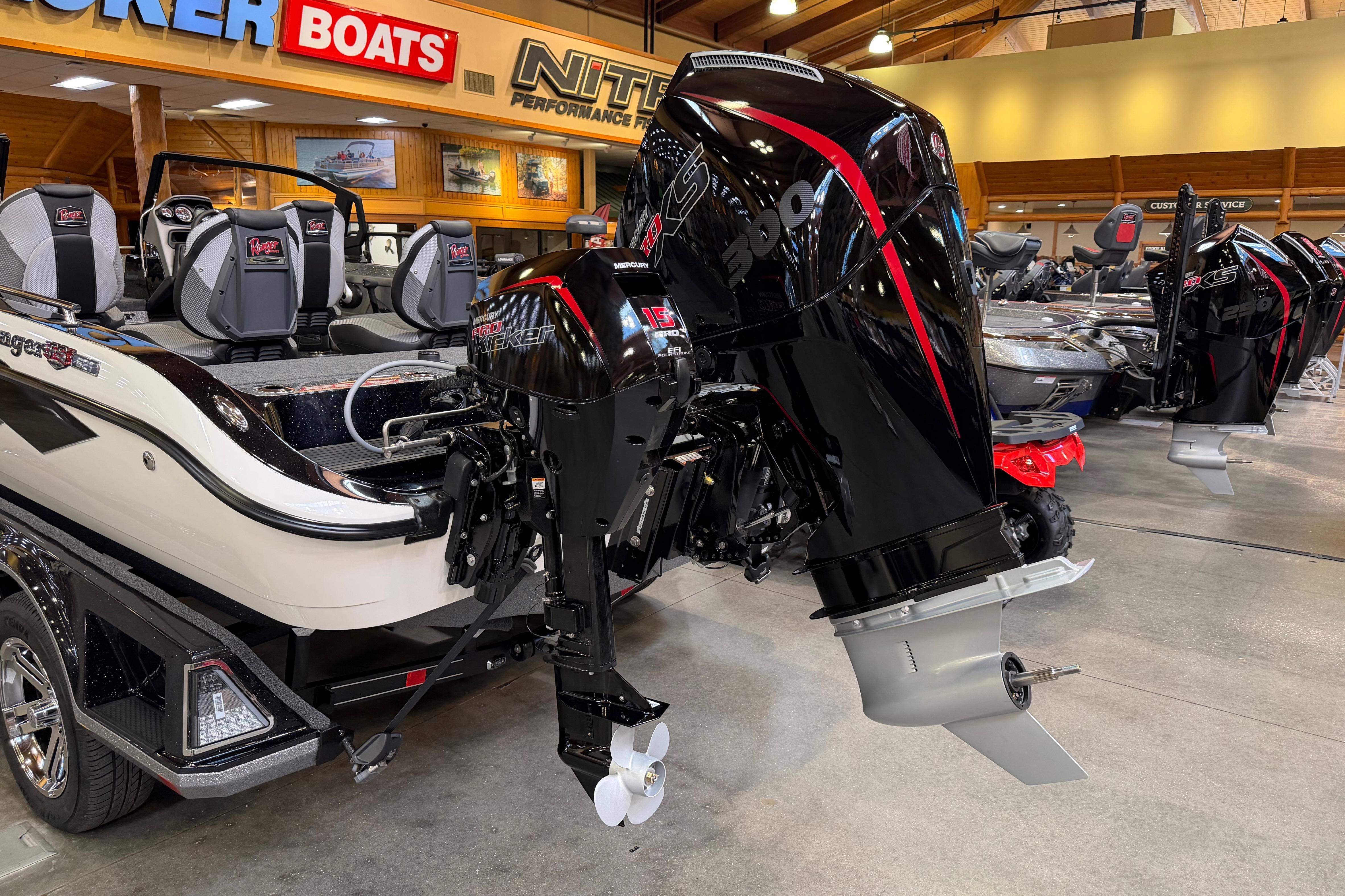 2026 Ranger 621FS Cup-Equipped boat with powerful outboard motor in showroom.