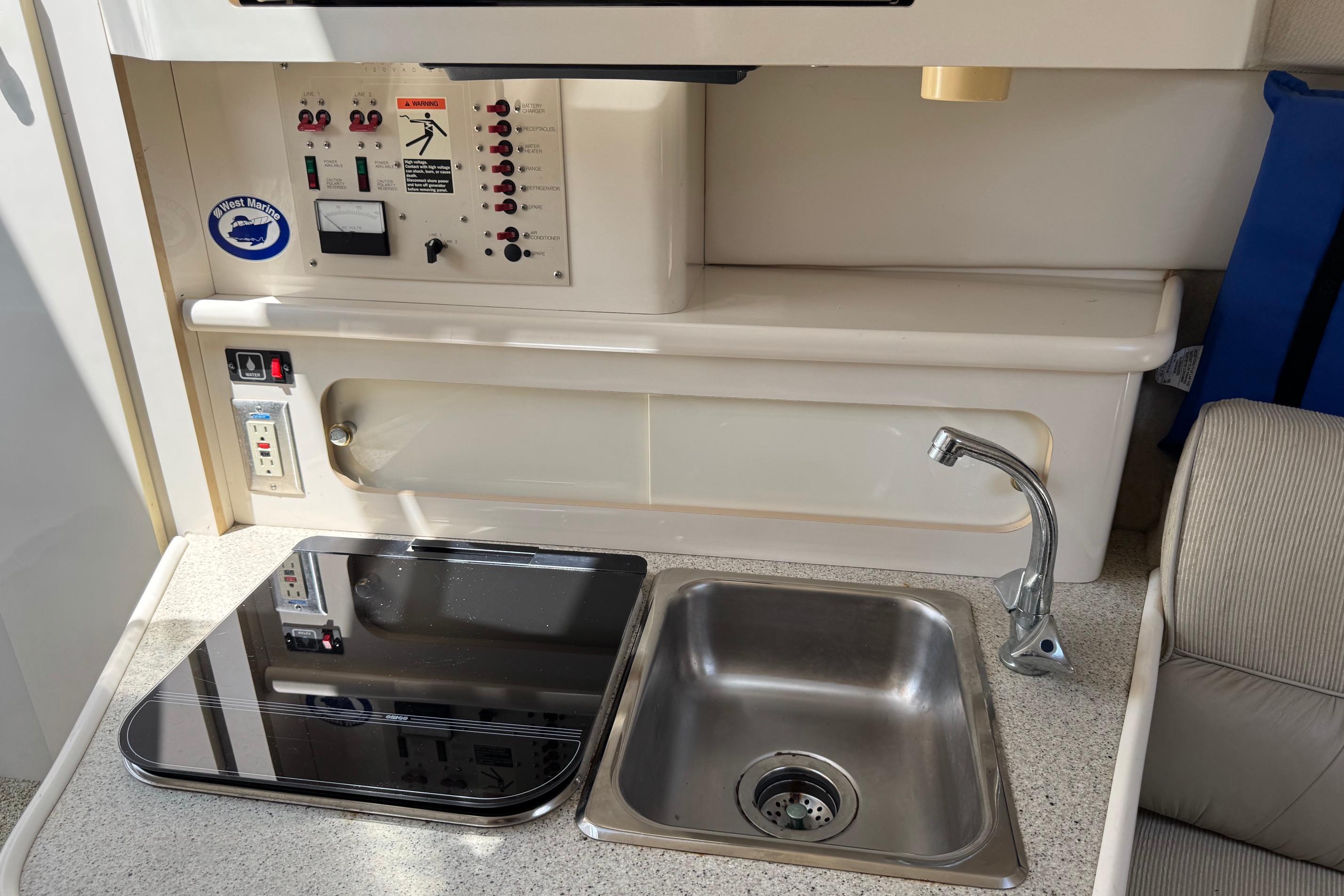 Interior of a 2000 Maxum 2400 SCR boat featuring a compact kitchen area.