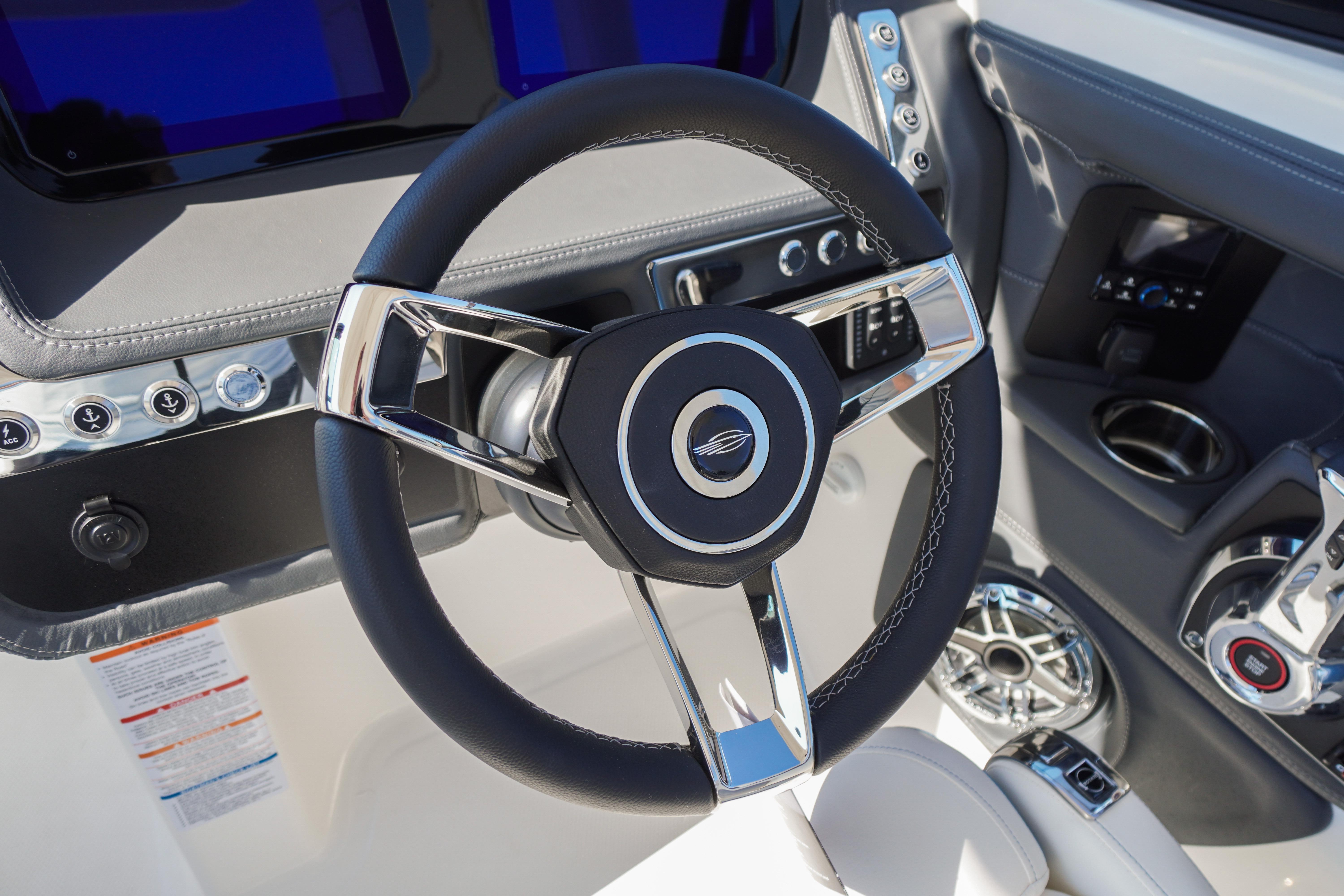 Steering wheel of 2026 Chaparral 270 OSX boat, featuring modern controls and sleek design.